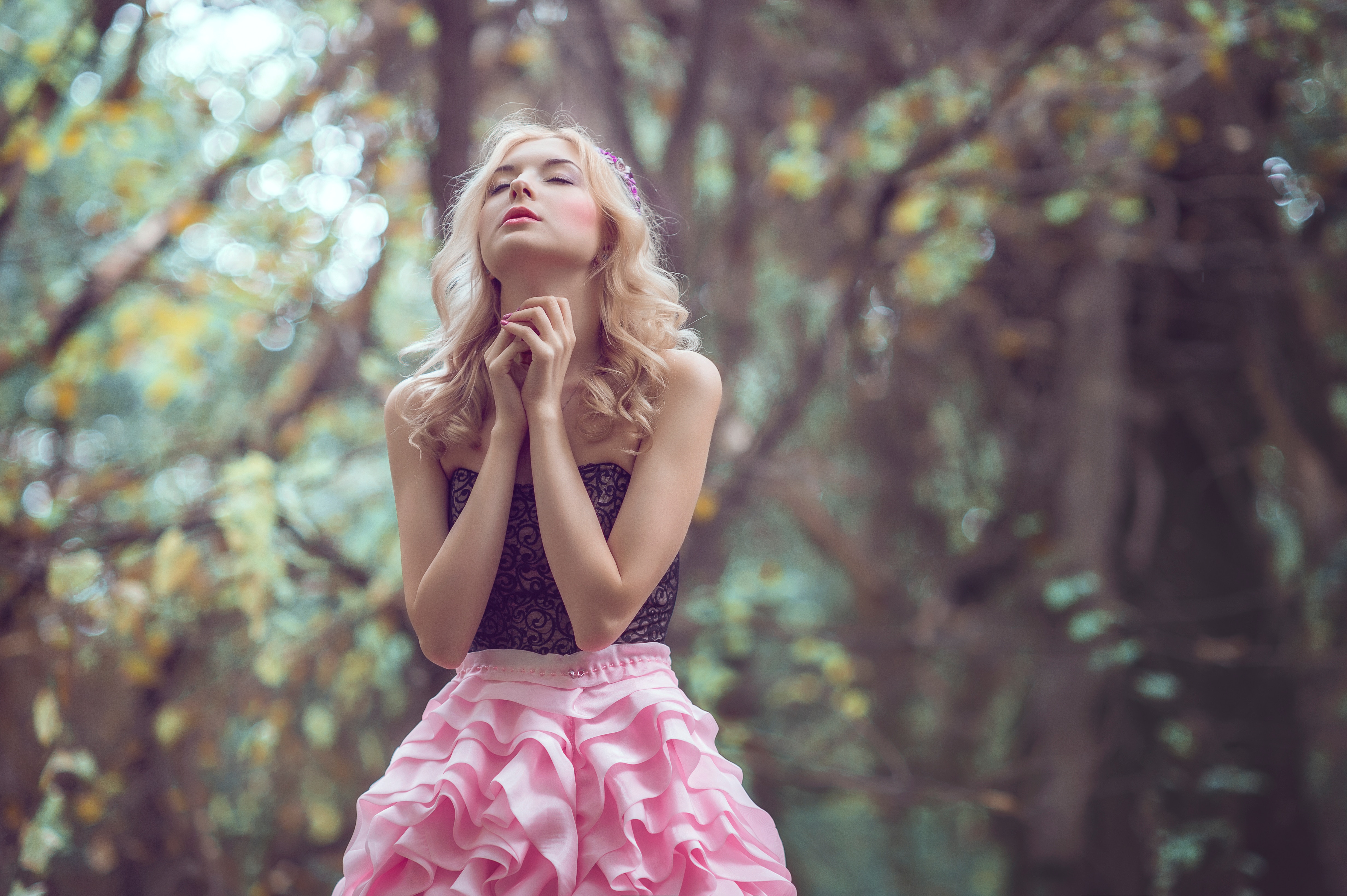 Woman in pink dress praying in forest HD Wallpaper