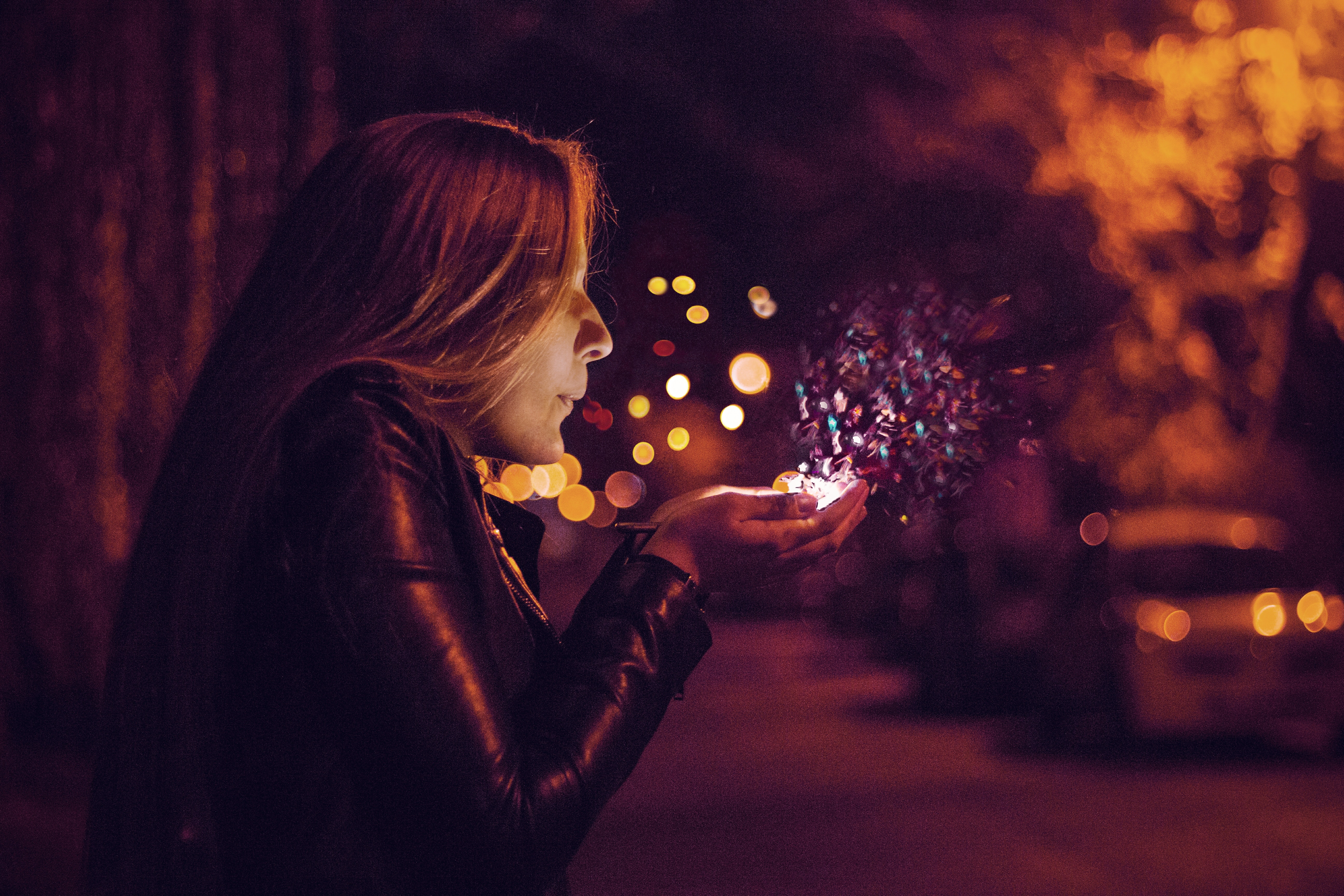 Woman blowing glitter at night with bokeh lights HD Wallpaper