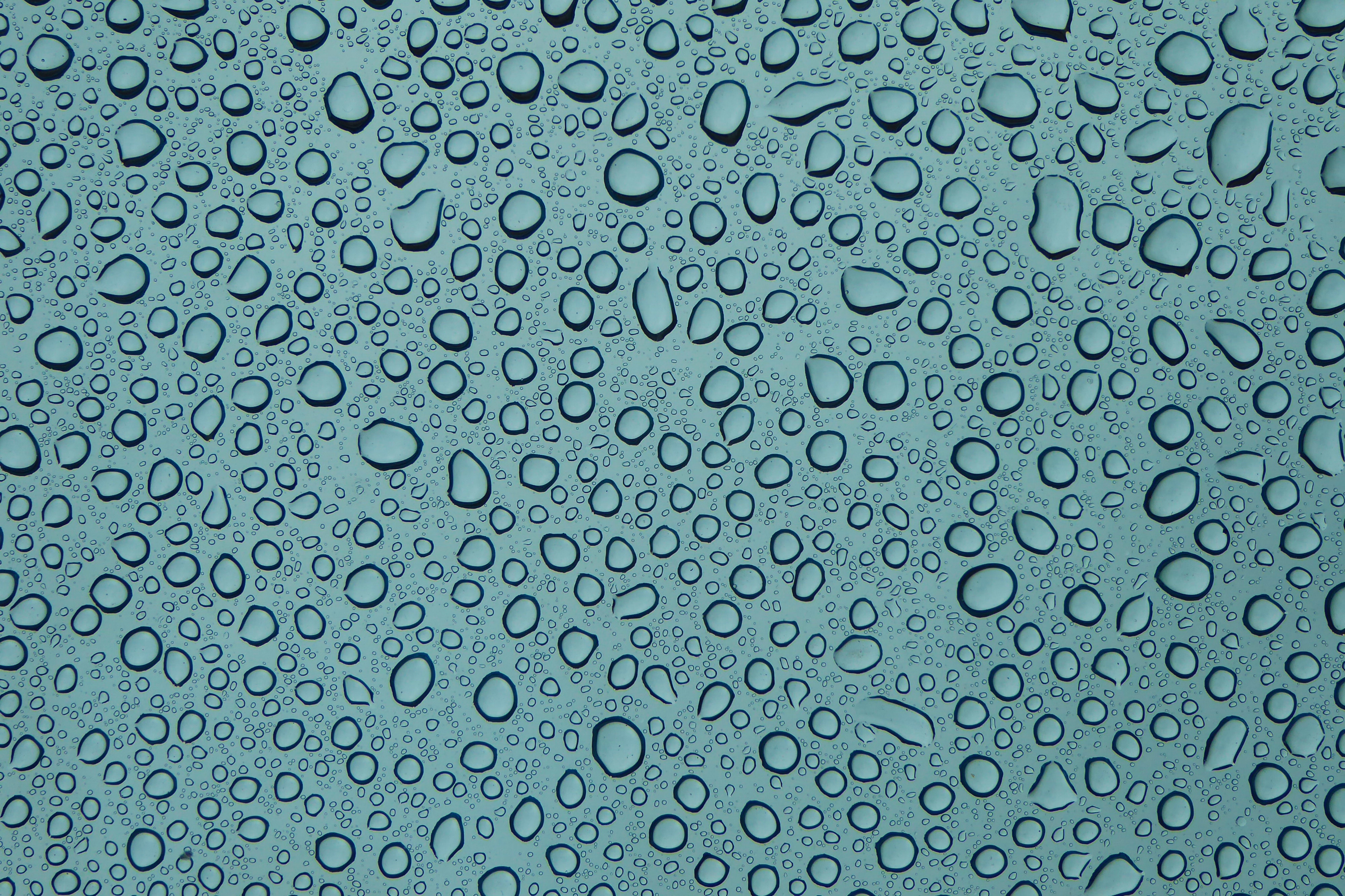 Water droplets on a blue glass surface HD Wallpaper