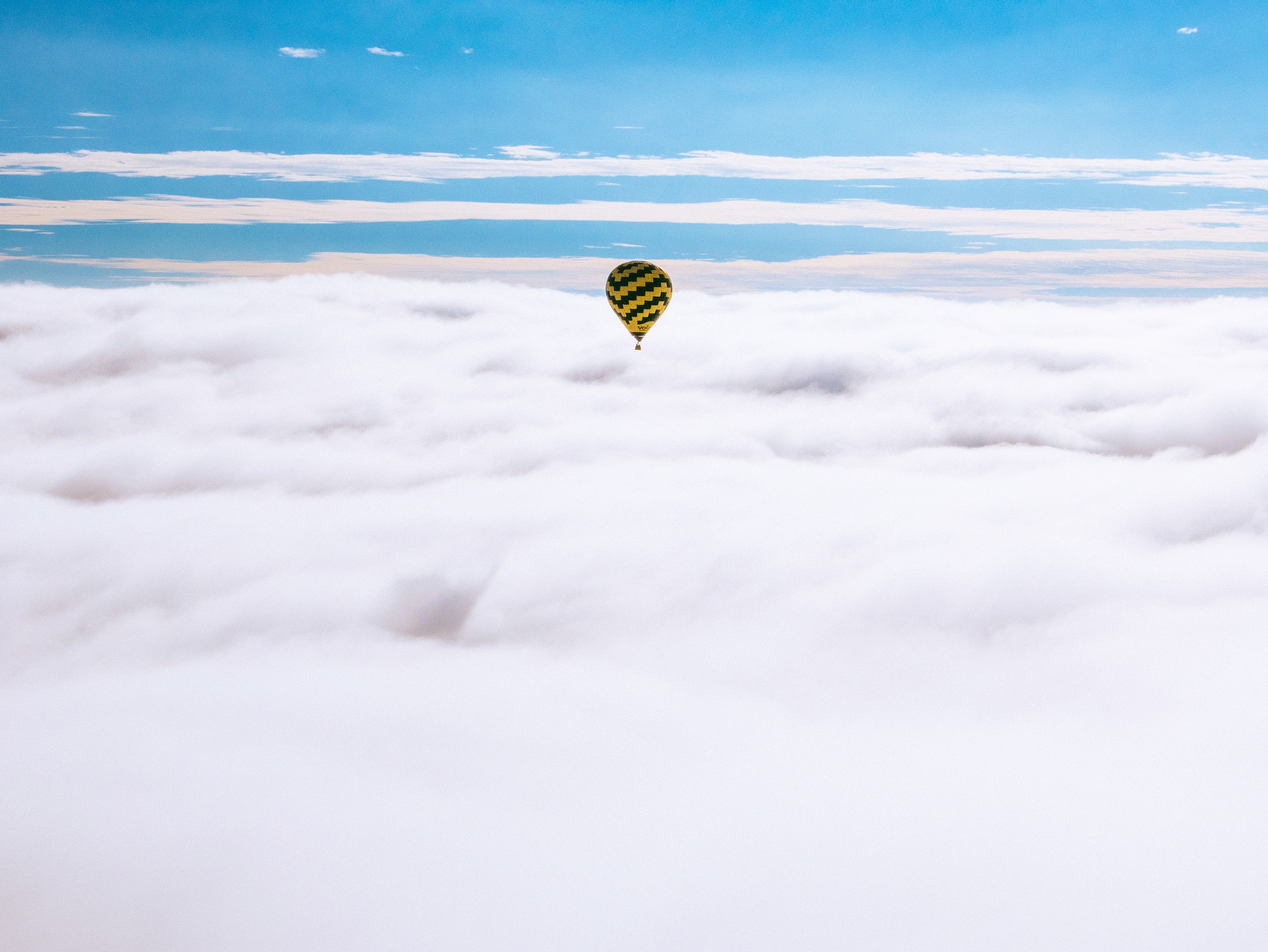 Hot air balloon flying over clouds in Mexico HD Wallpaper