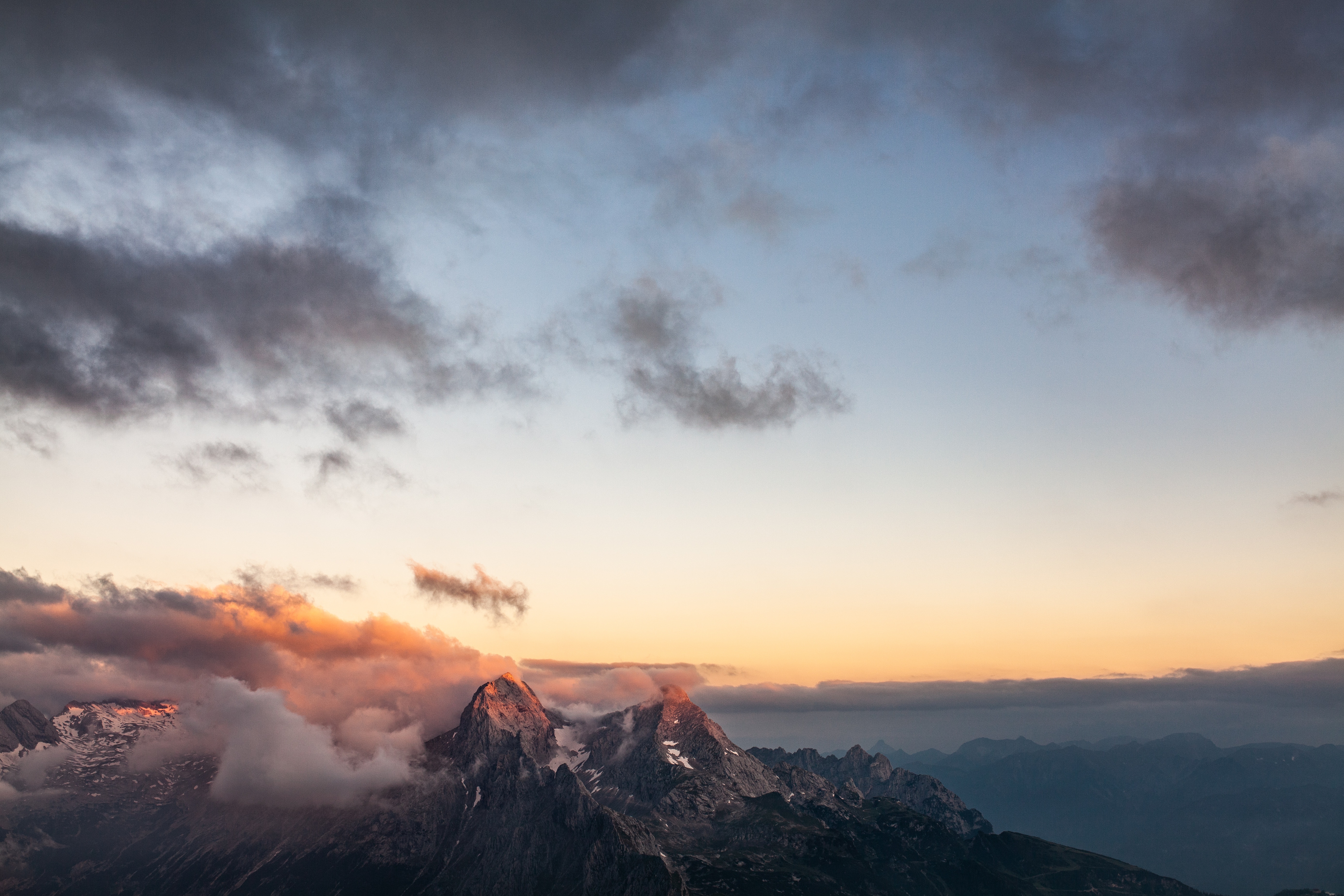 Mountain peaks at sunset with clouds HD Wallpaper