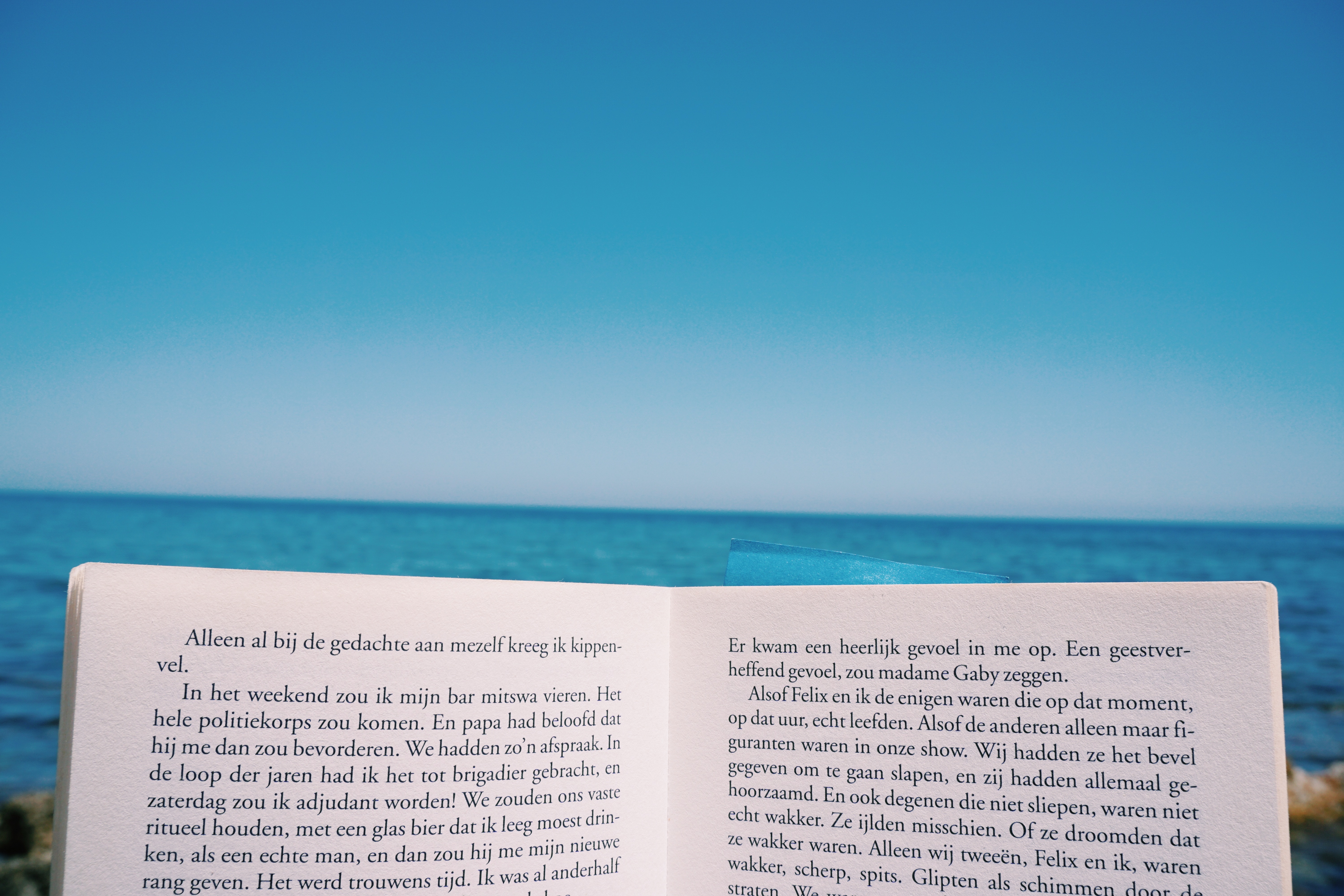 Open book on a beach with the sea and sky HD Wallpaper