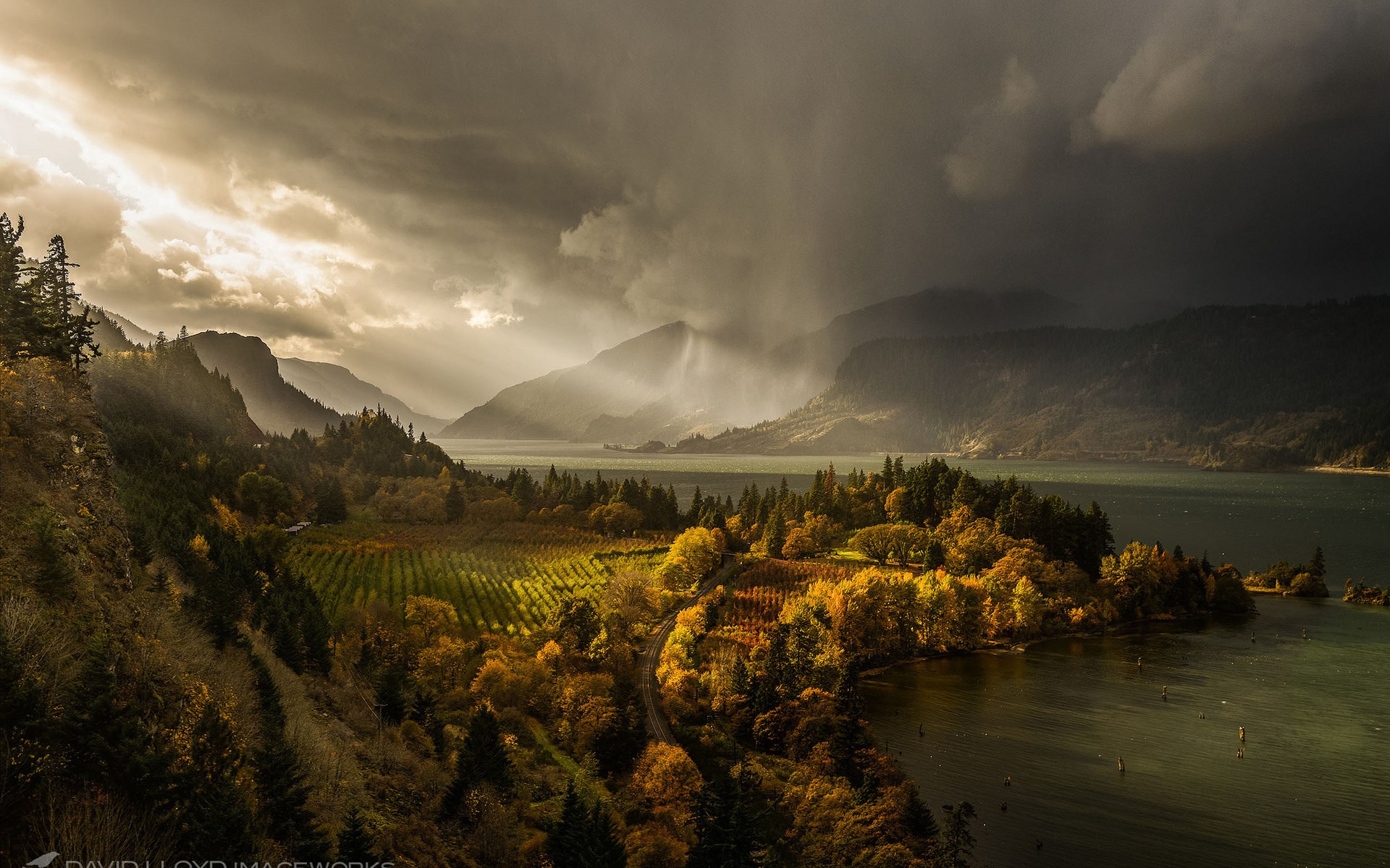 Stormy sky over a river valley with autumn trees HD Wallpaper