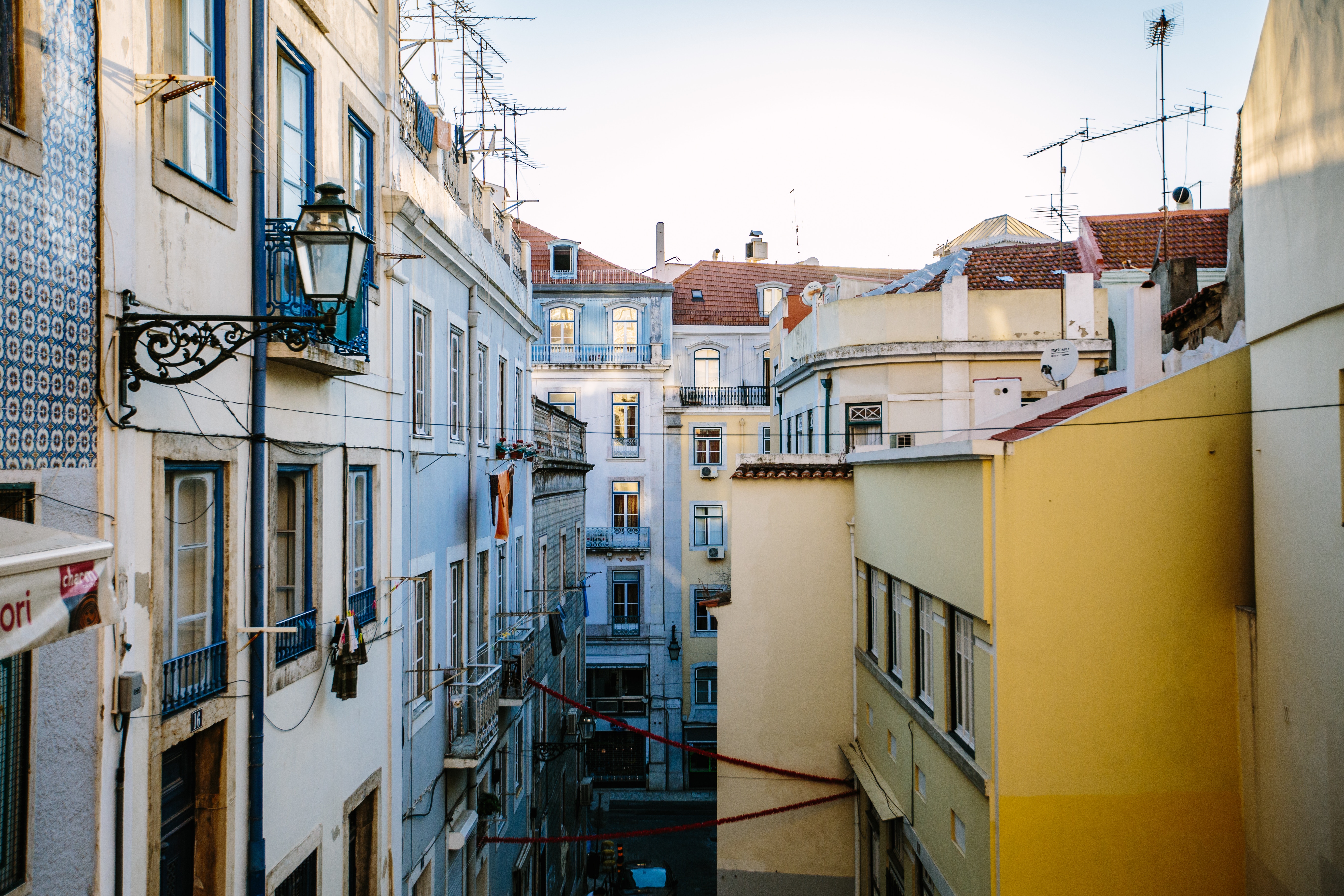 Lisbon street with colorful buildings and balconies HD Wallpaper