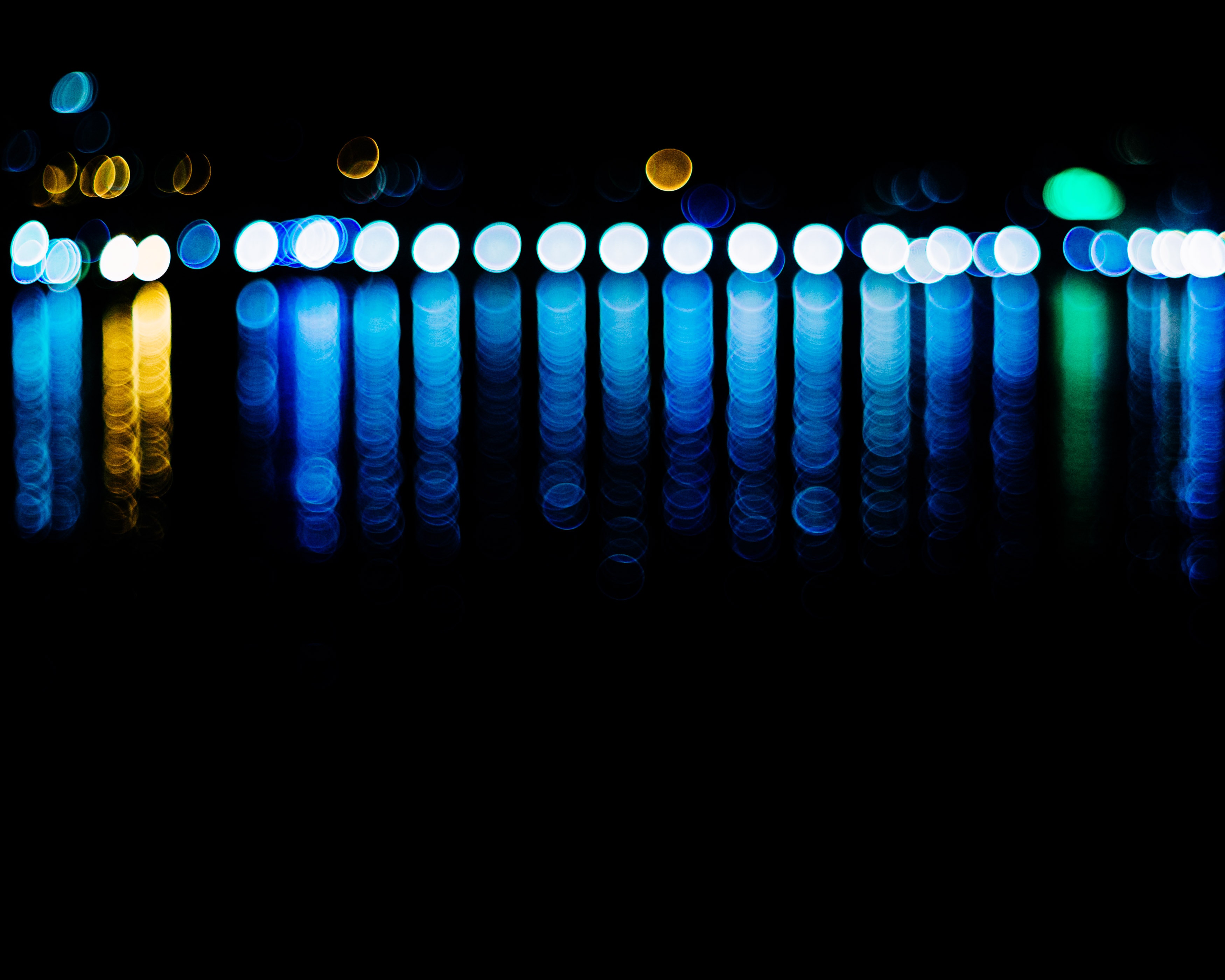 Abstract bokeh lights reflecting on water at night HD Wallpaper