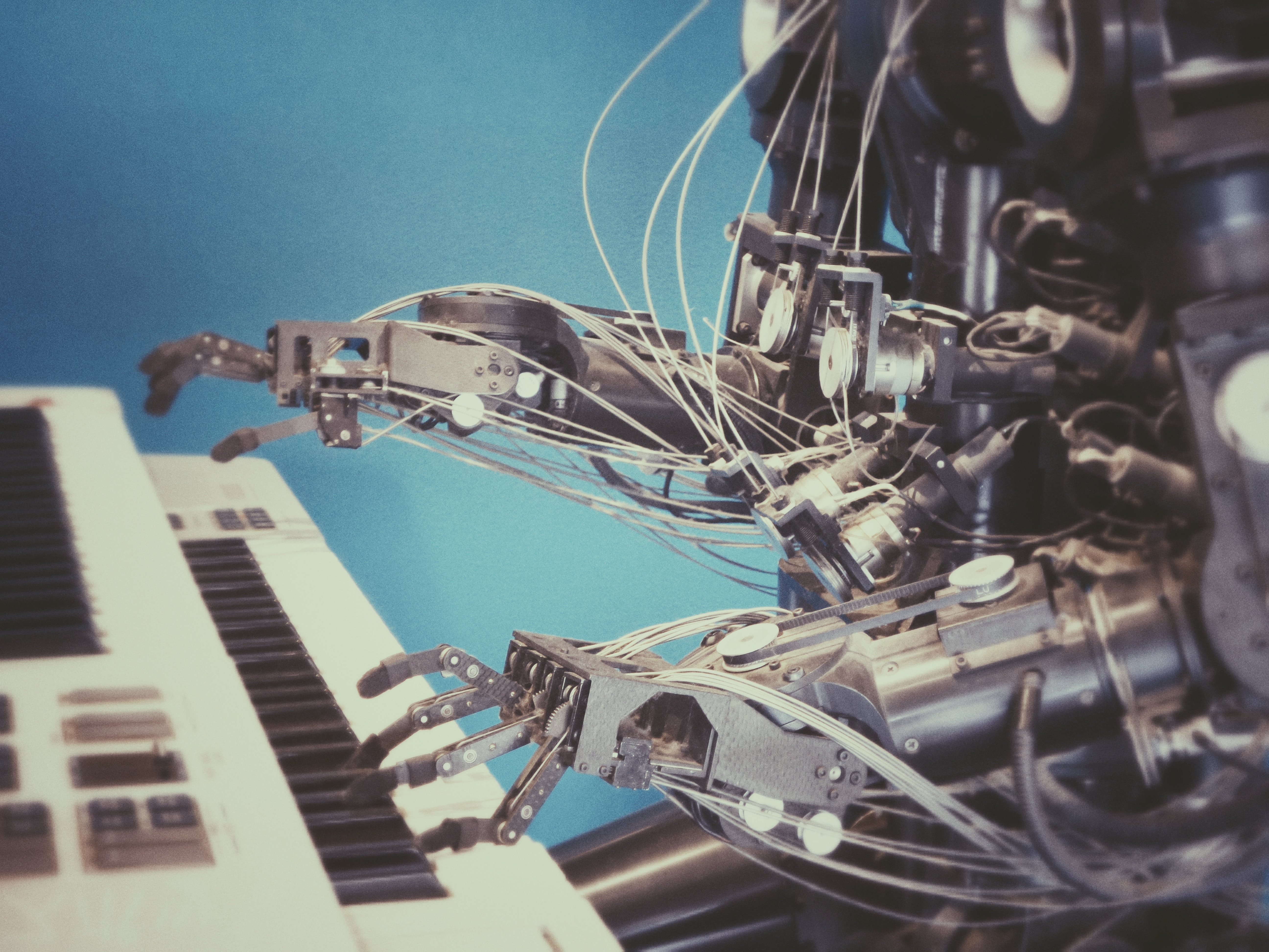 Robot playing a keyboard with many wires HD Wallpaper
