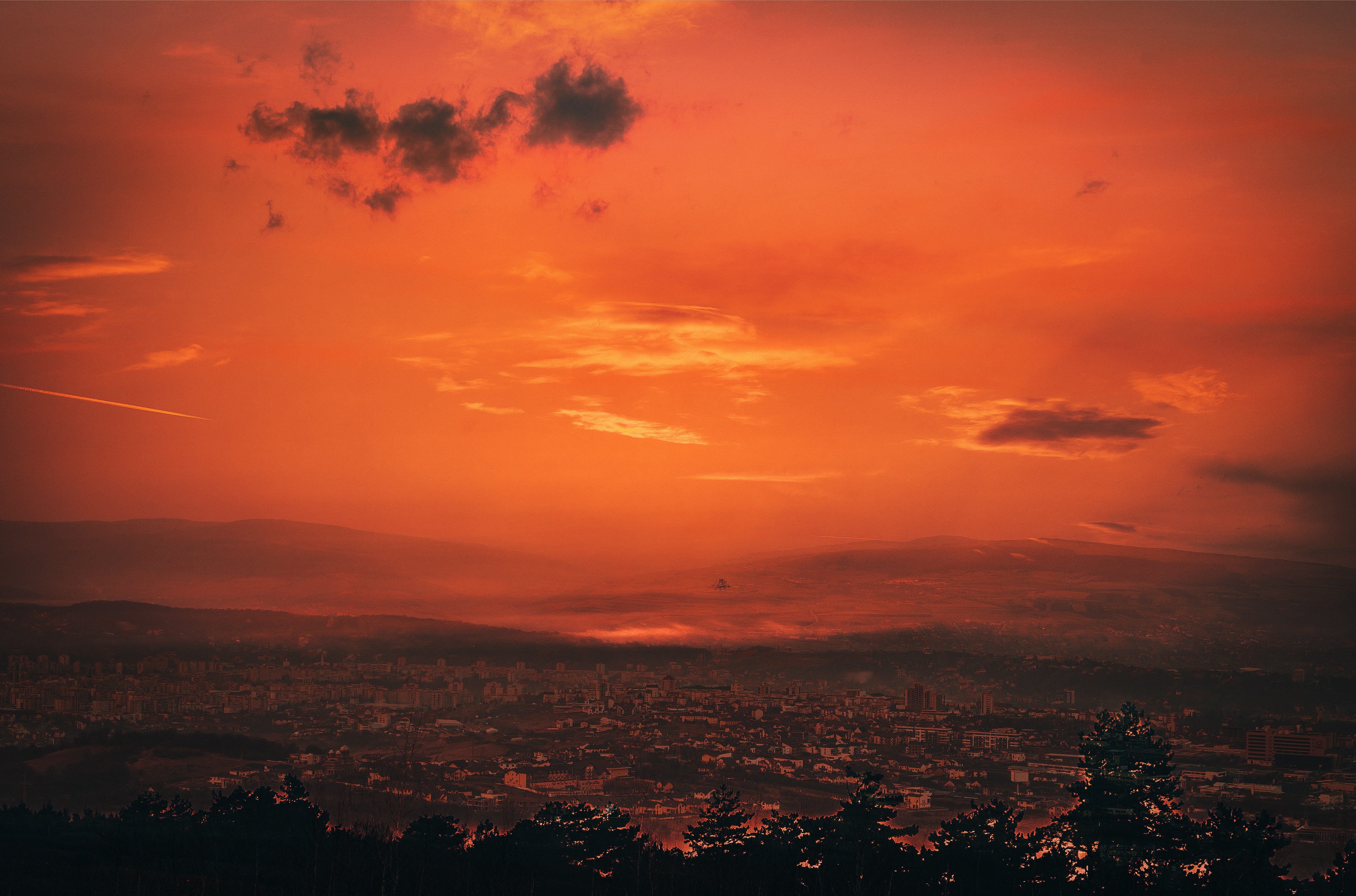 Cluj-Napoca city at sunset with orange sky and clouds HD Wallpaper