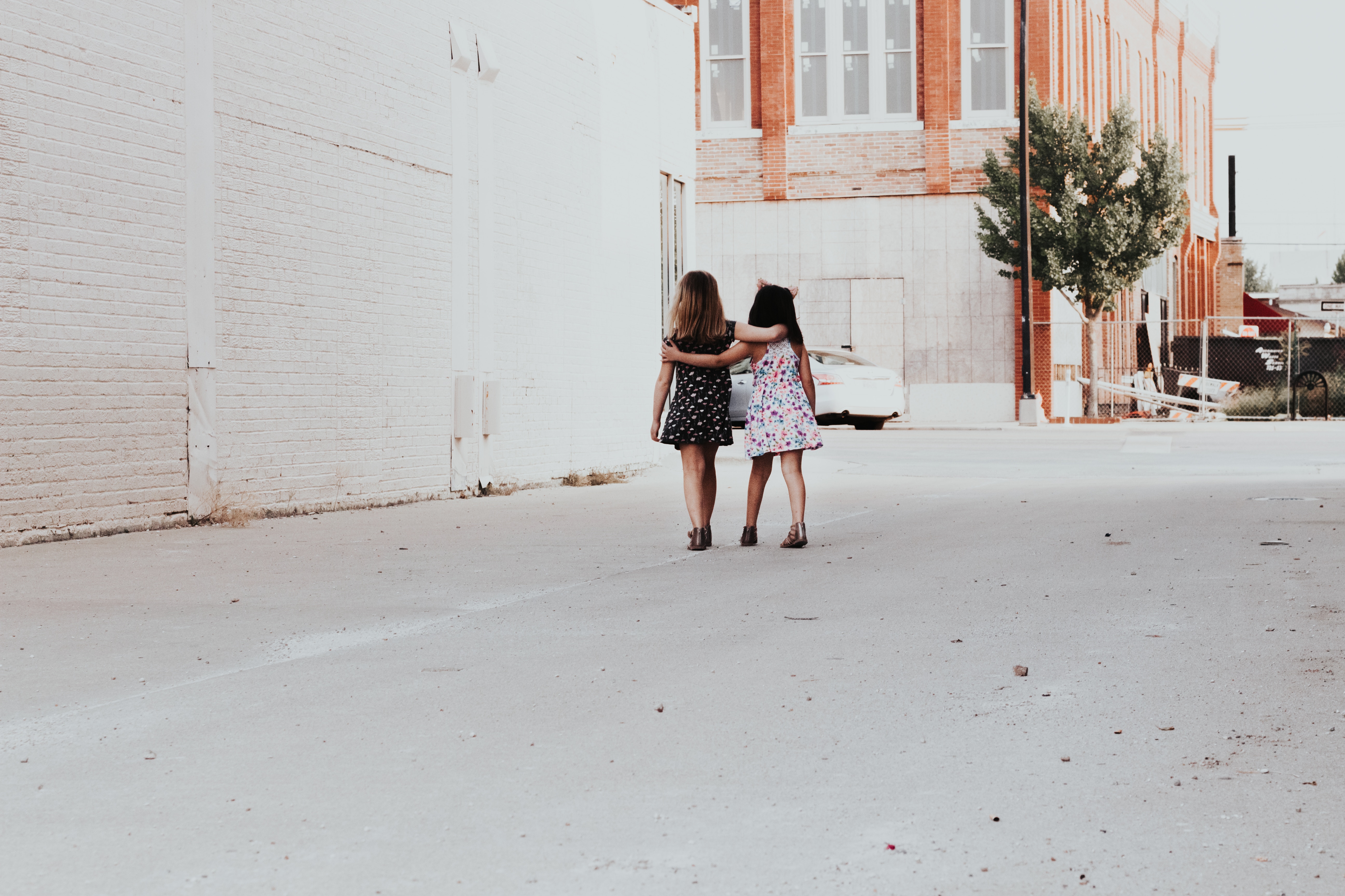 Two girls walking down a city street HD Wallpaper