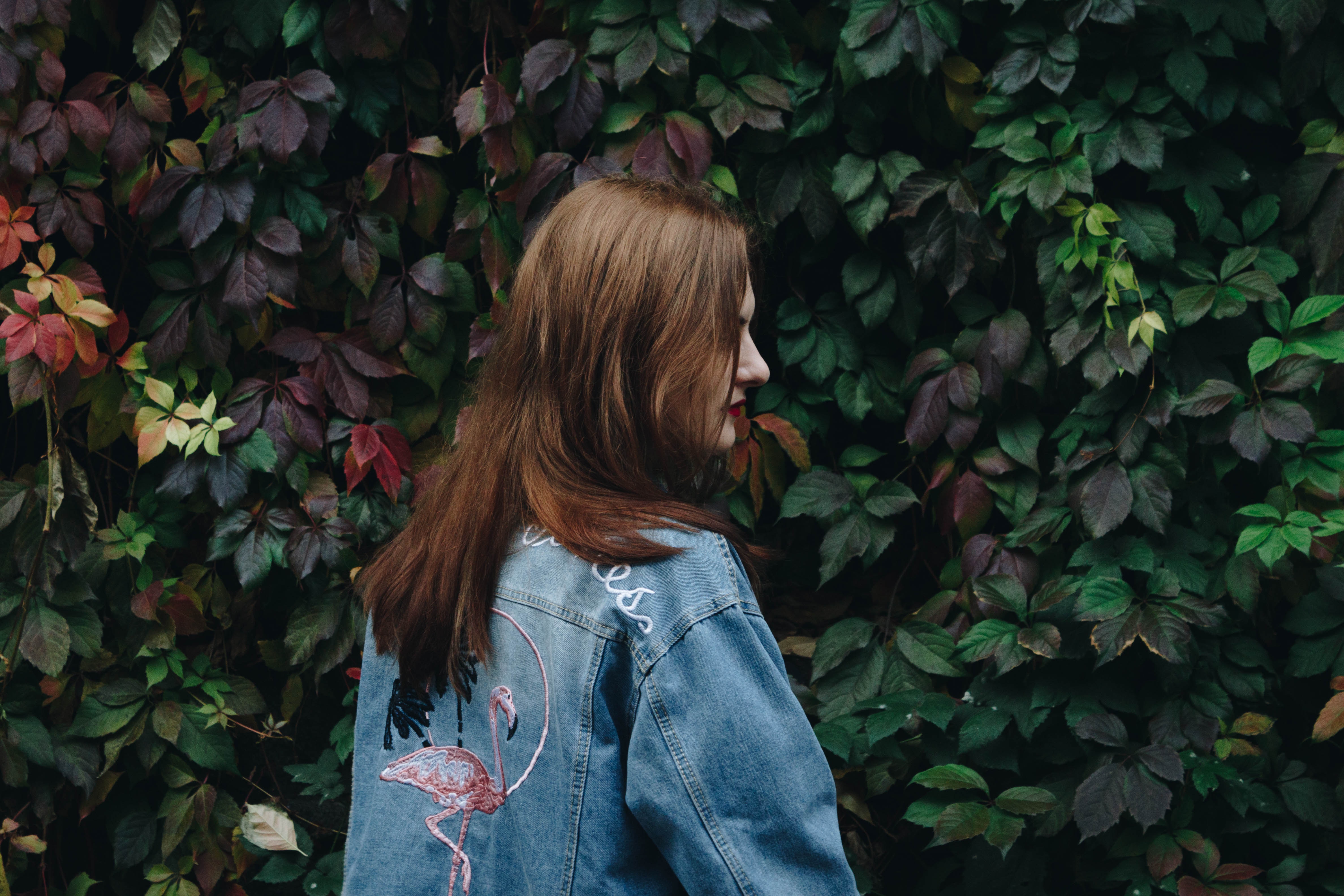Woman in denim jacket with flamingo design HD Wallpaper