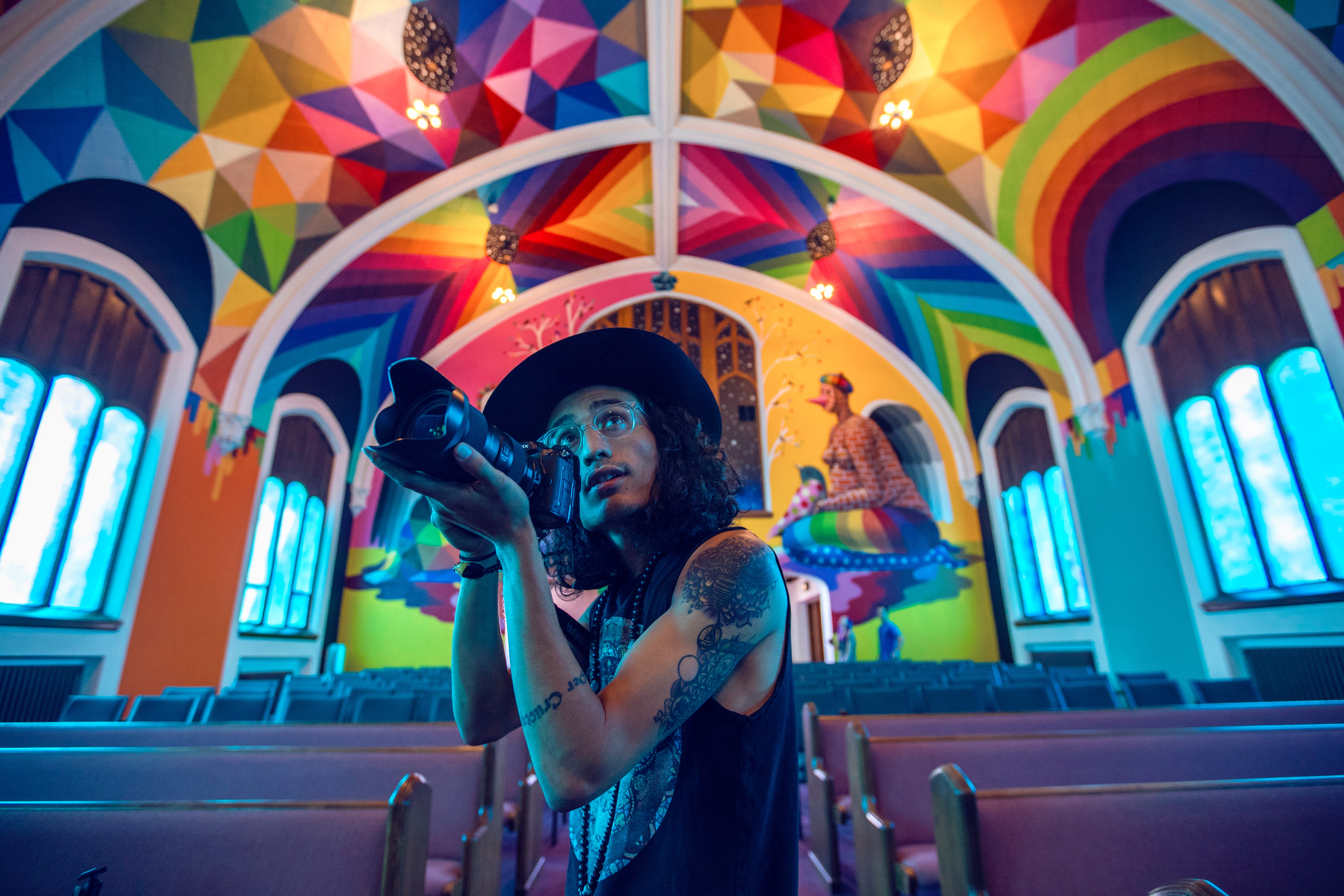 Man with camera in a colorful church HD Wallpaper