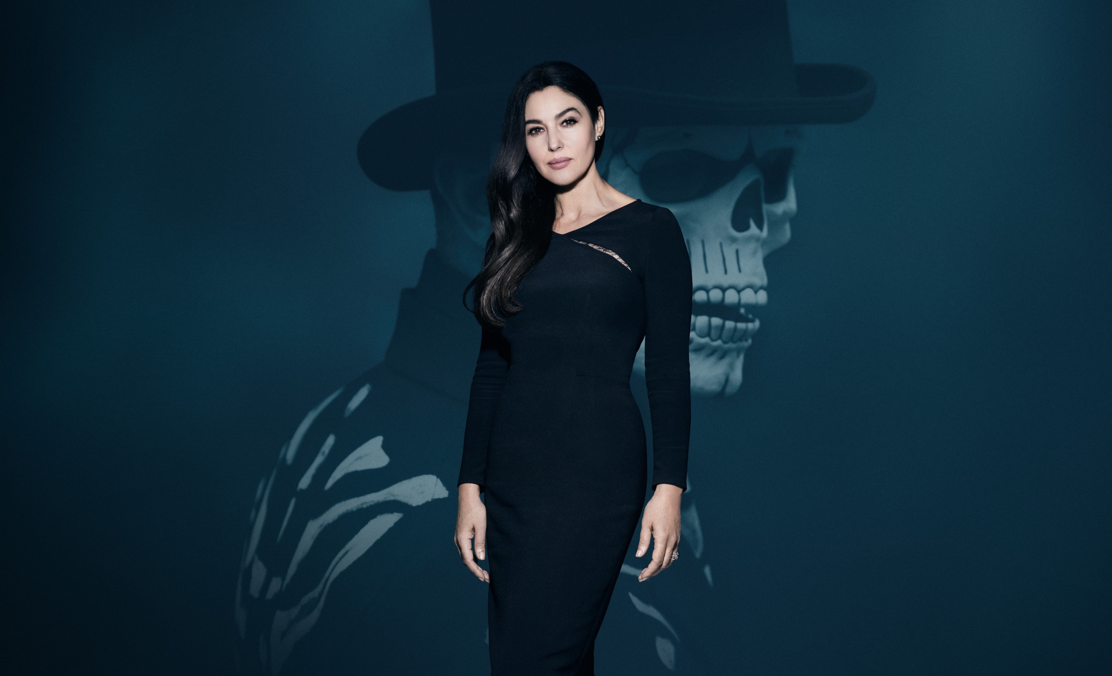 Monica Bellucci in a black dress with a skeleton in the background HD Wallpaper