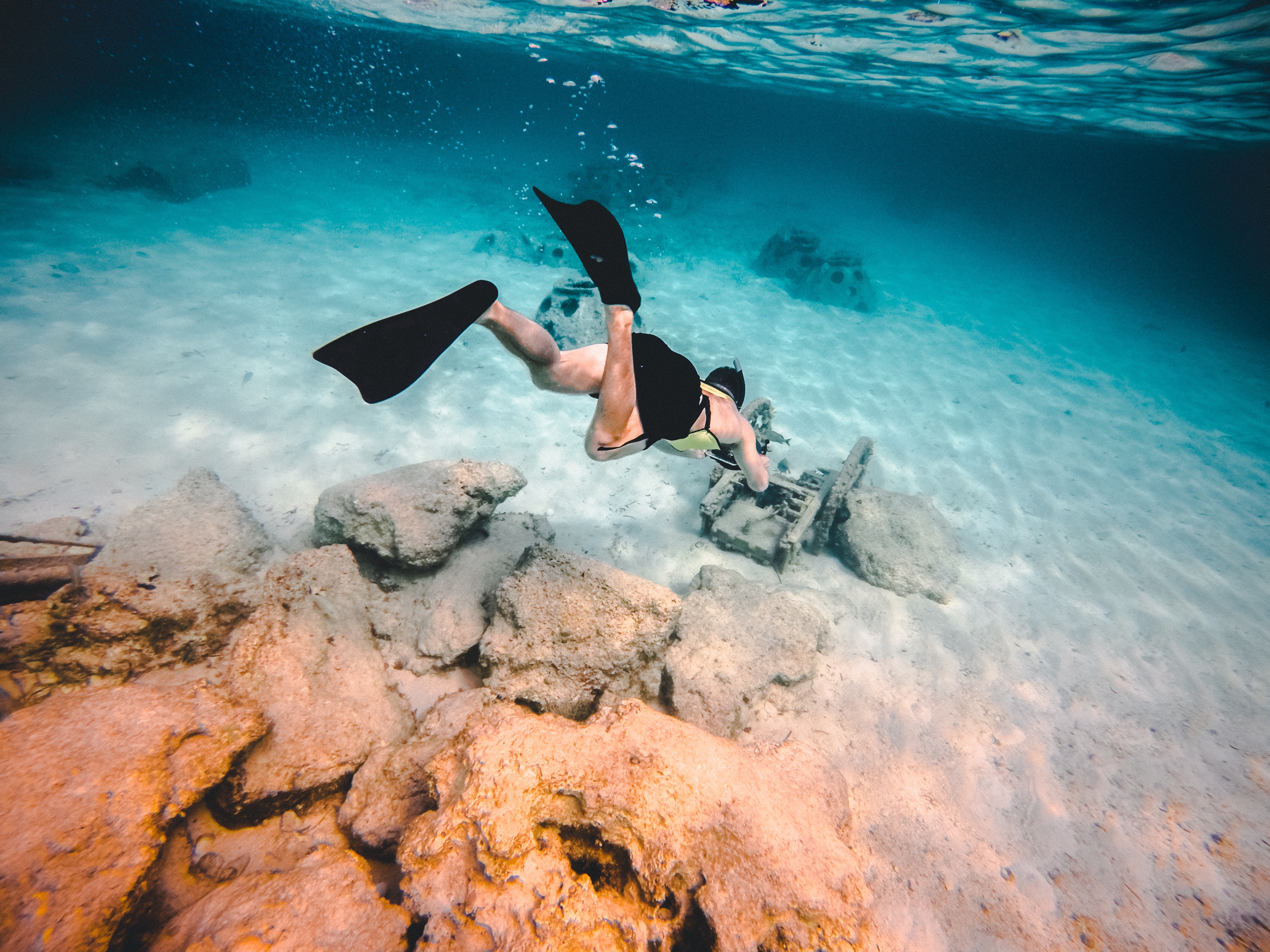 Man snorkeling near underwater ruins HD Wallpaper