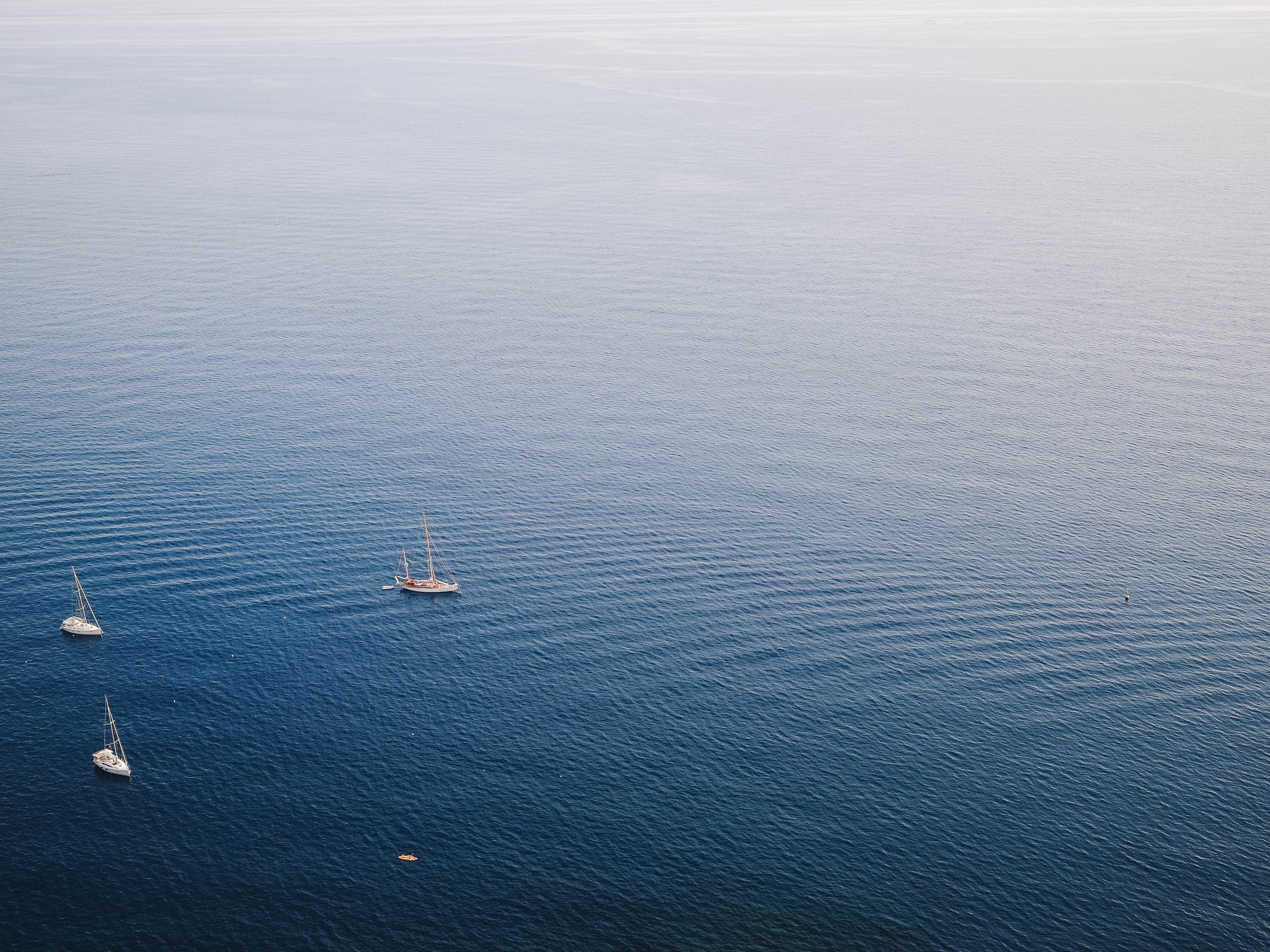 Sailboats on the blue ocean from an aerial view HD Wallpaper