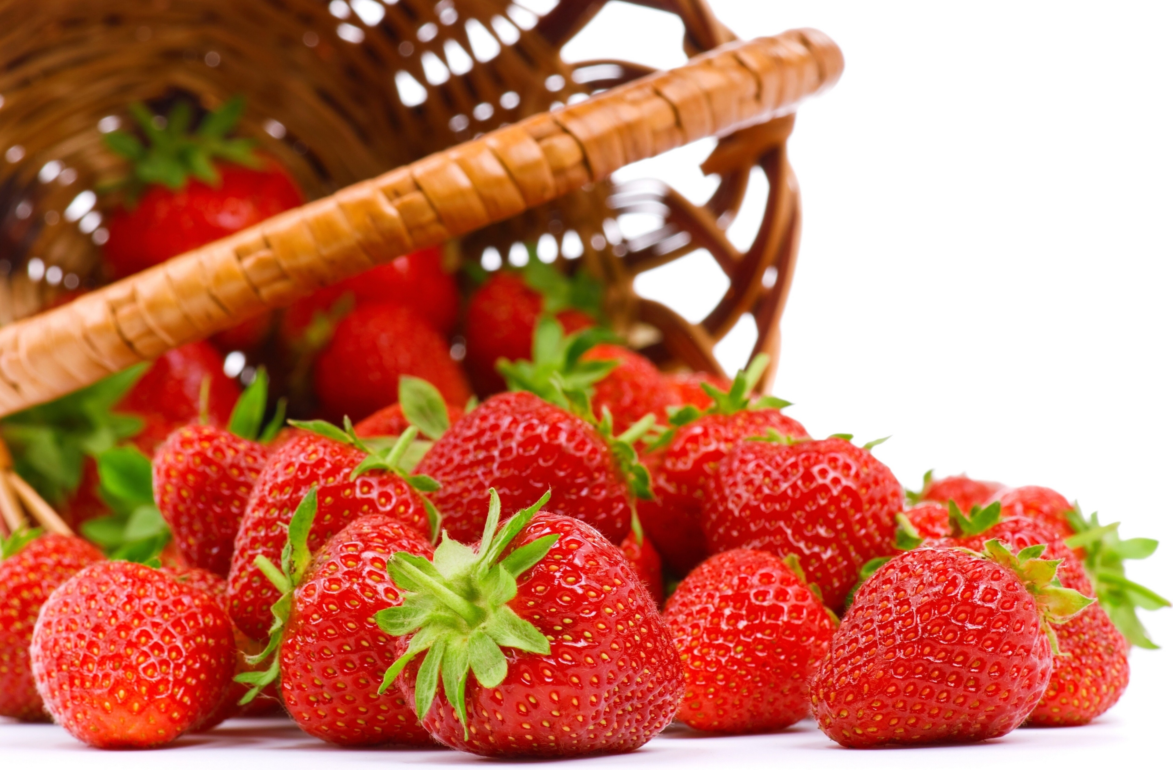 Strawberries spilling from a basket HD Wallpaper