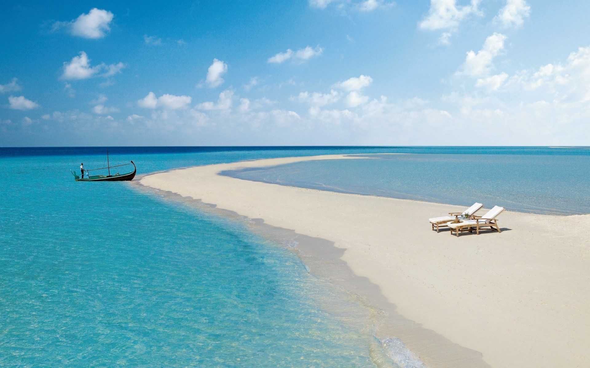 Tropical beach with chaise lounges and a boat HD Wallpaper