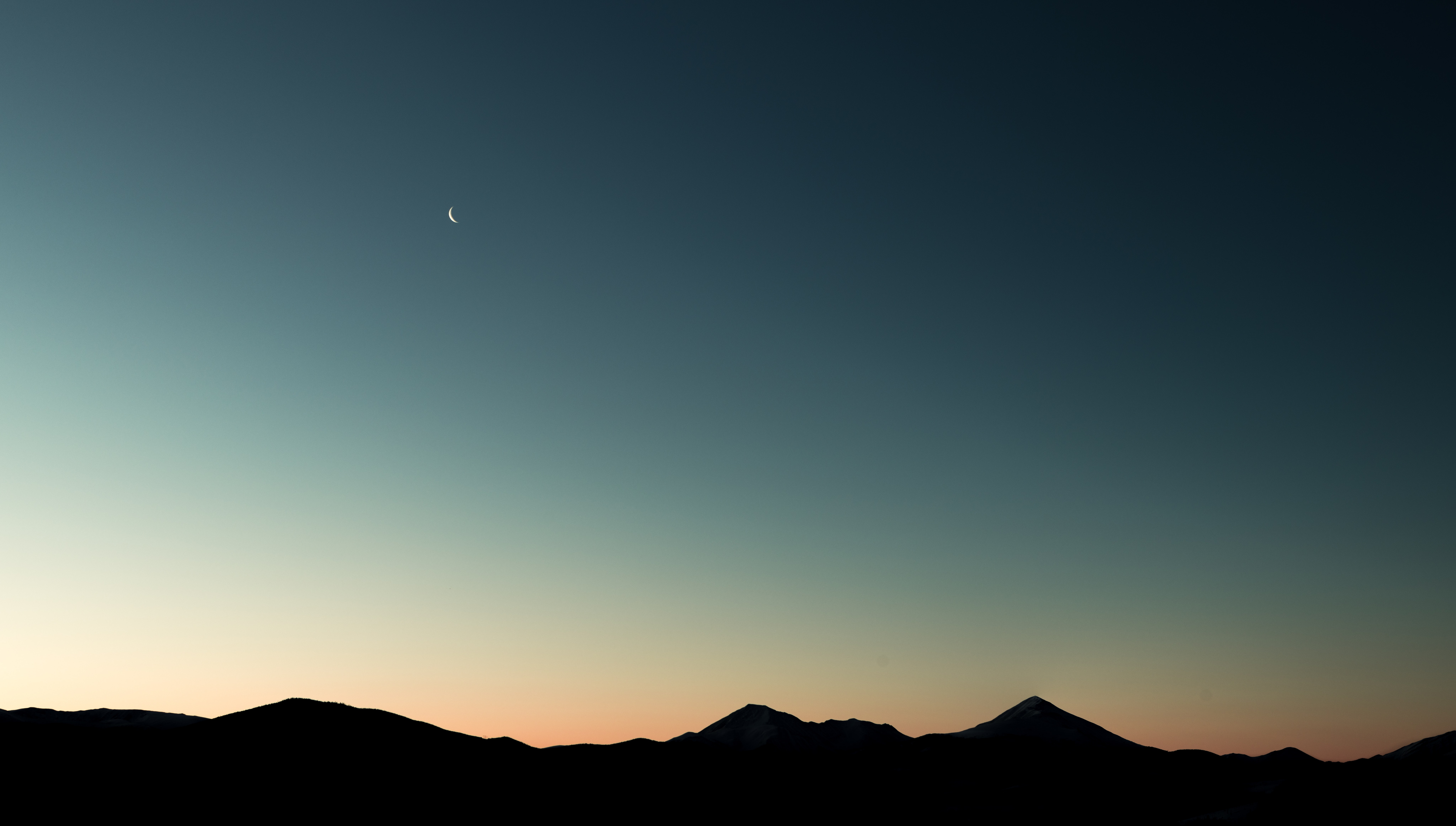 Crescent moon over silhouetted mountains at sunset HD Wallpaper