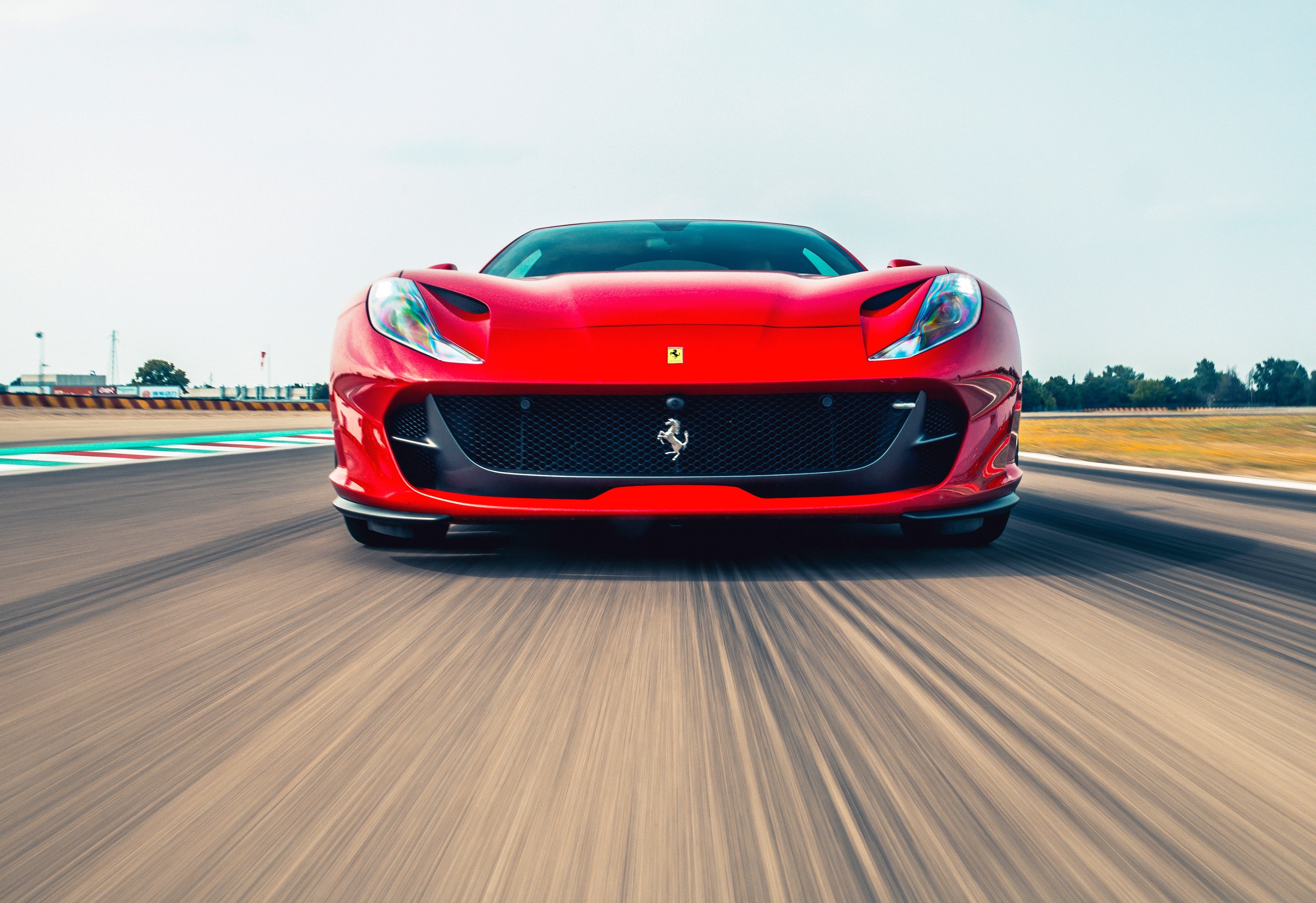 Red Ferrari 812 Superfast on a Racetrack HD Wallpaper