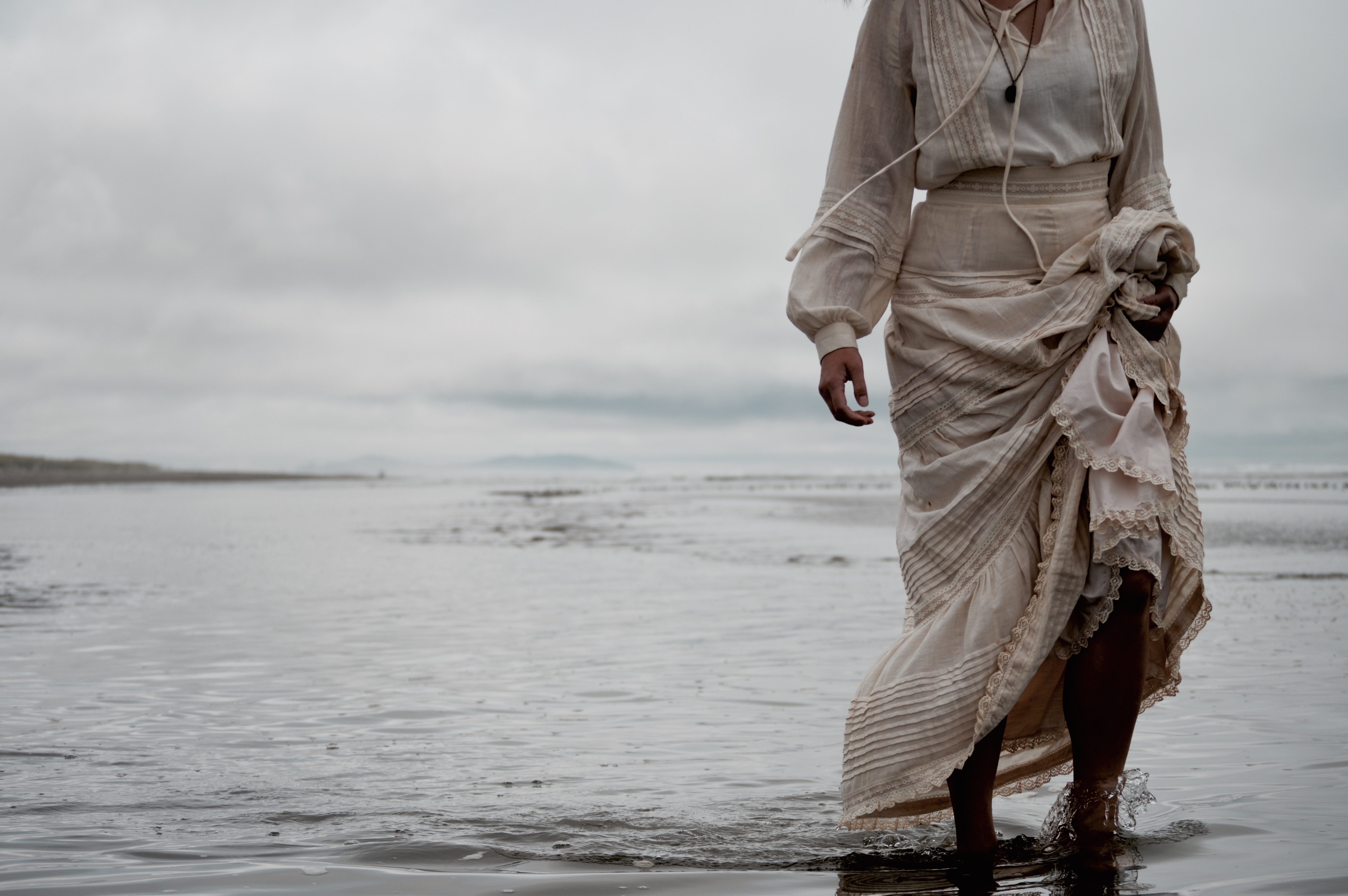 Woman in a dress walking on a beach HD Wallpaper