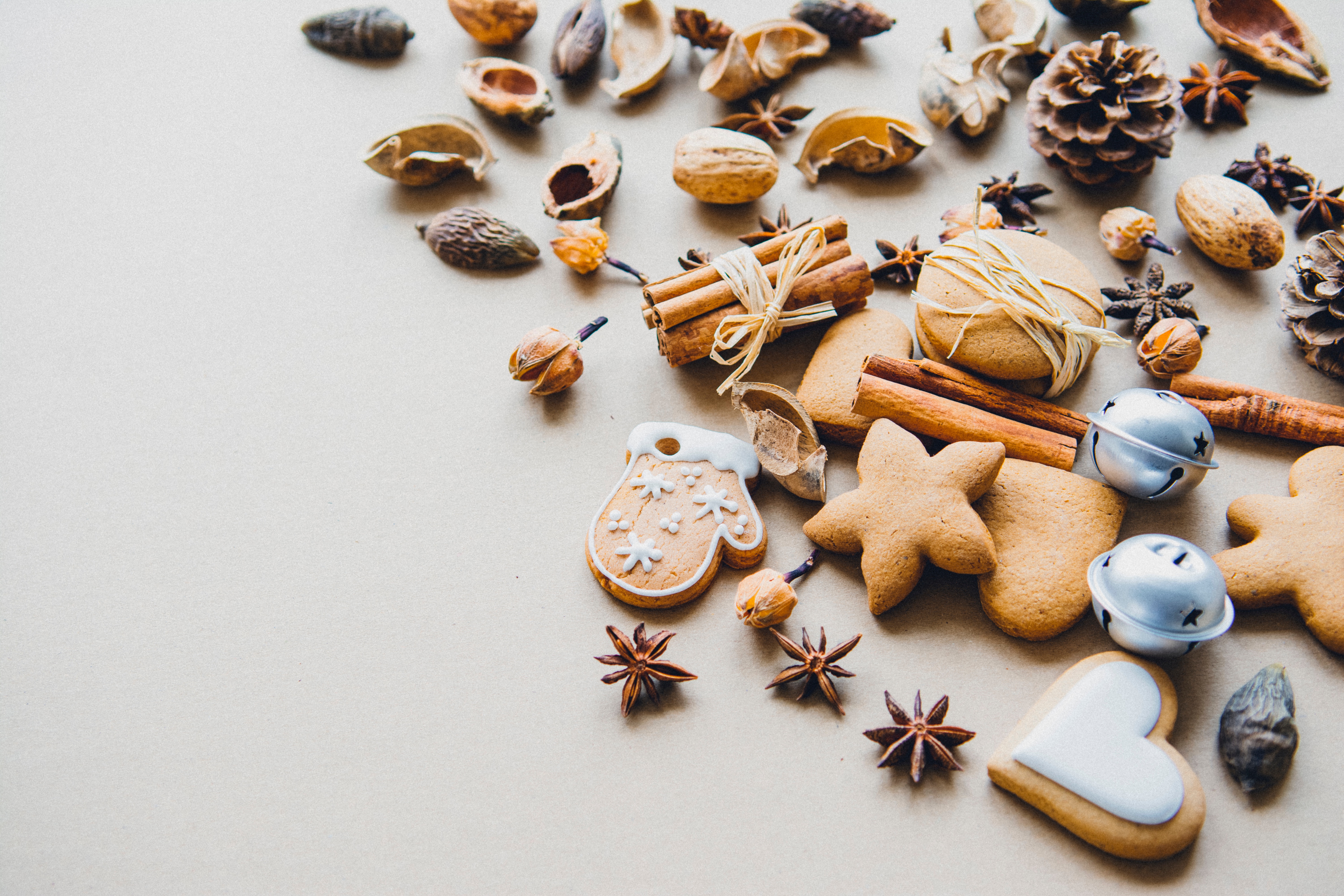 Christmas cookies, cinnamon sticks, pine cones, and bells HD Wallpaper