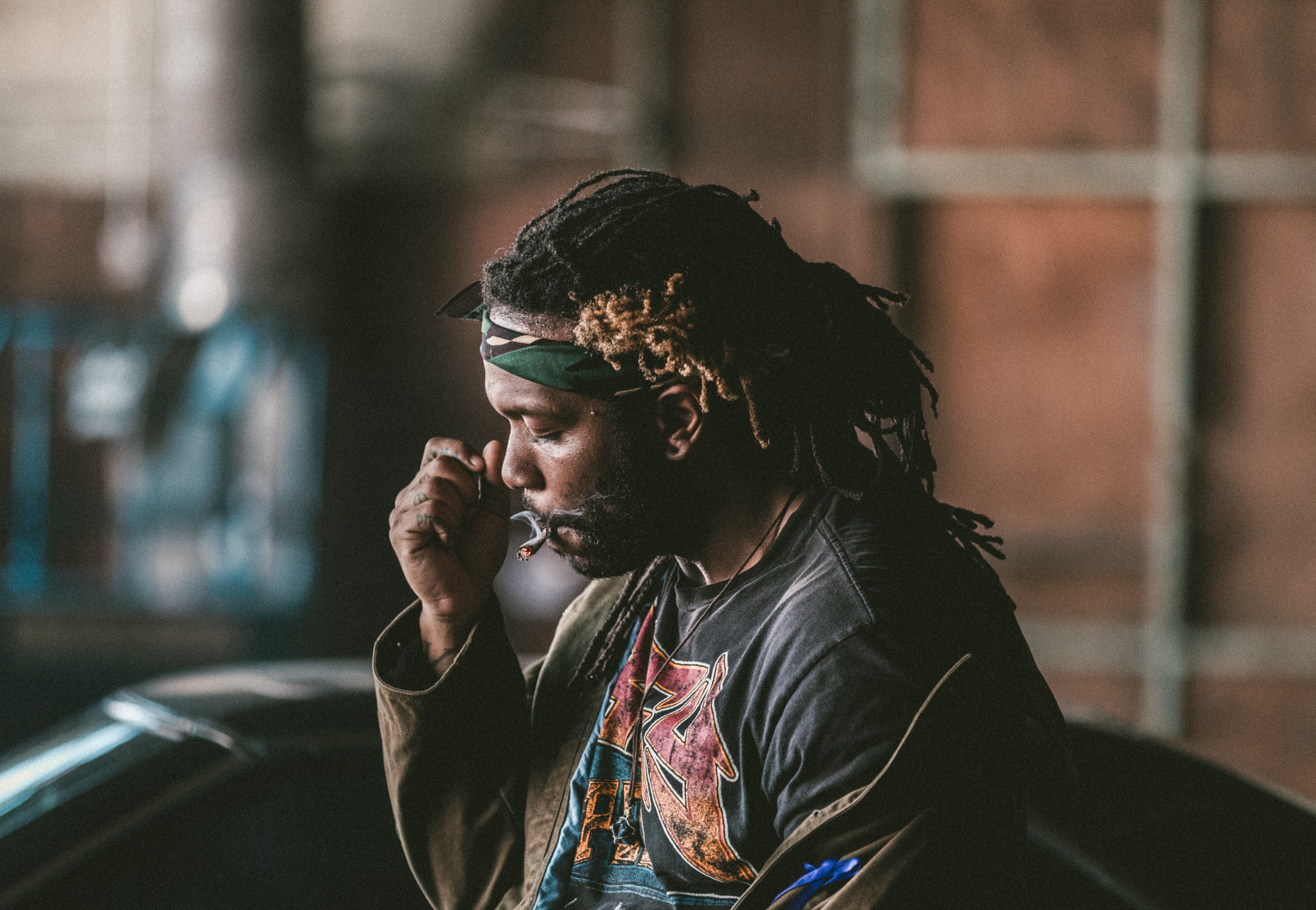 Man with dreadlocks smoking a cigarette HD Wallpaper