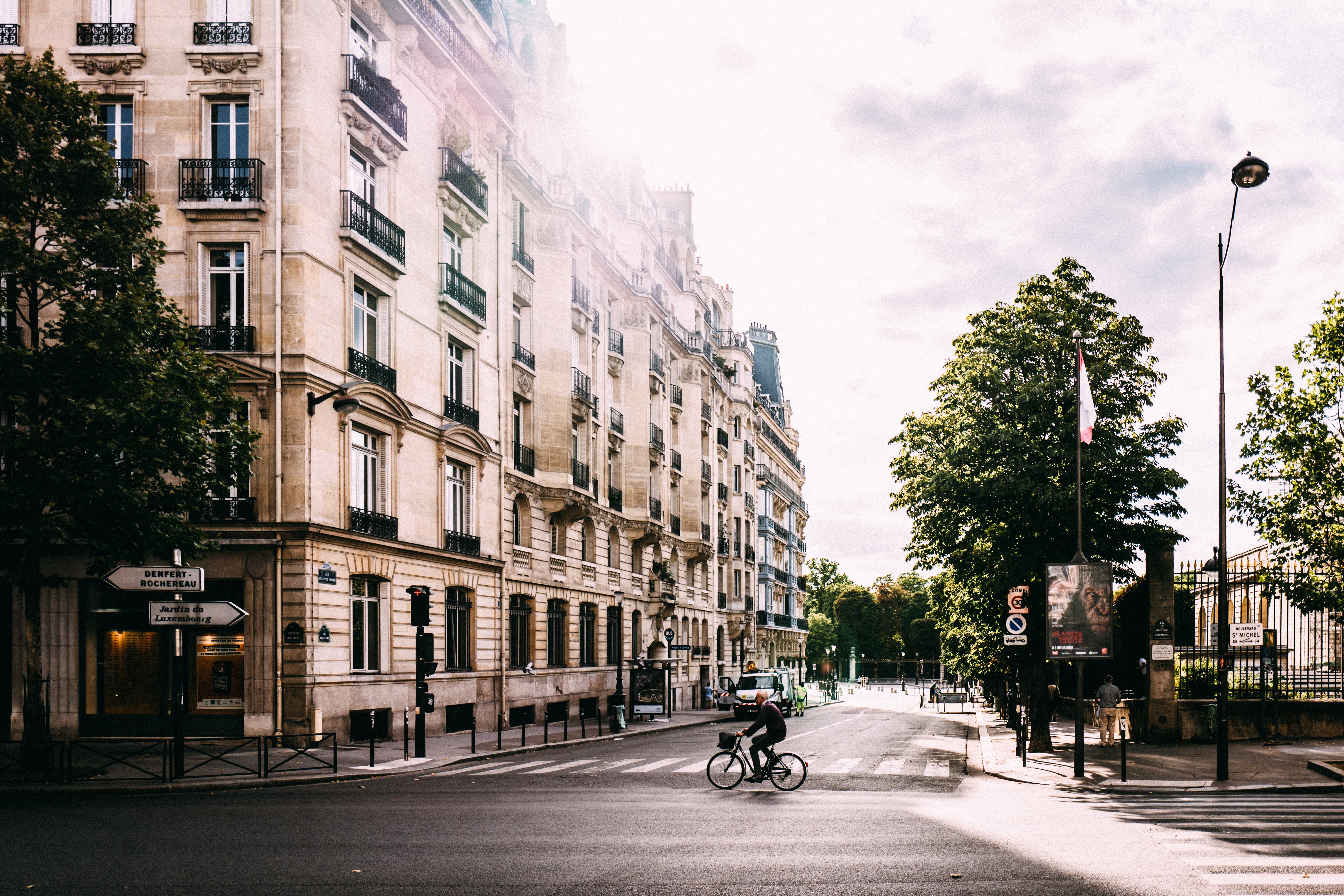 Cyclist on a Parisian street with old buildings HD Wallpaper