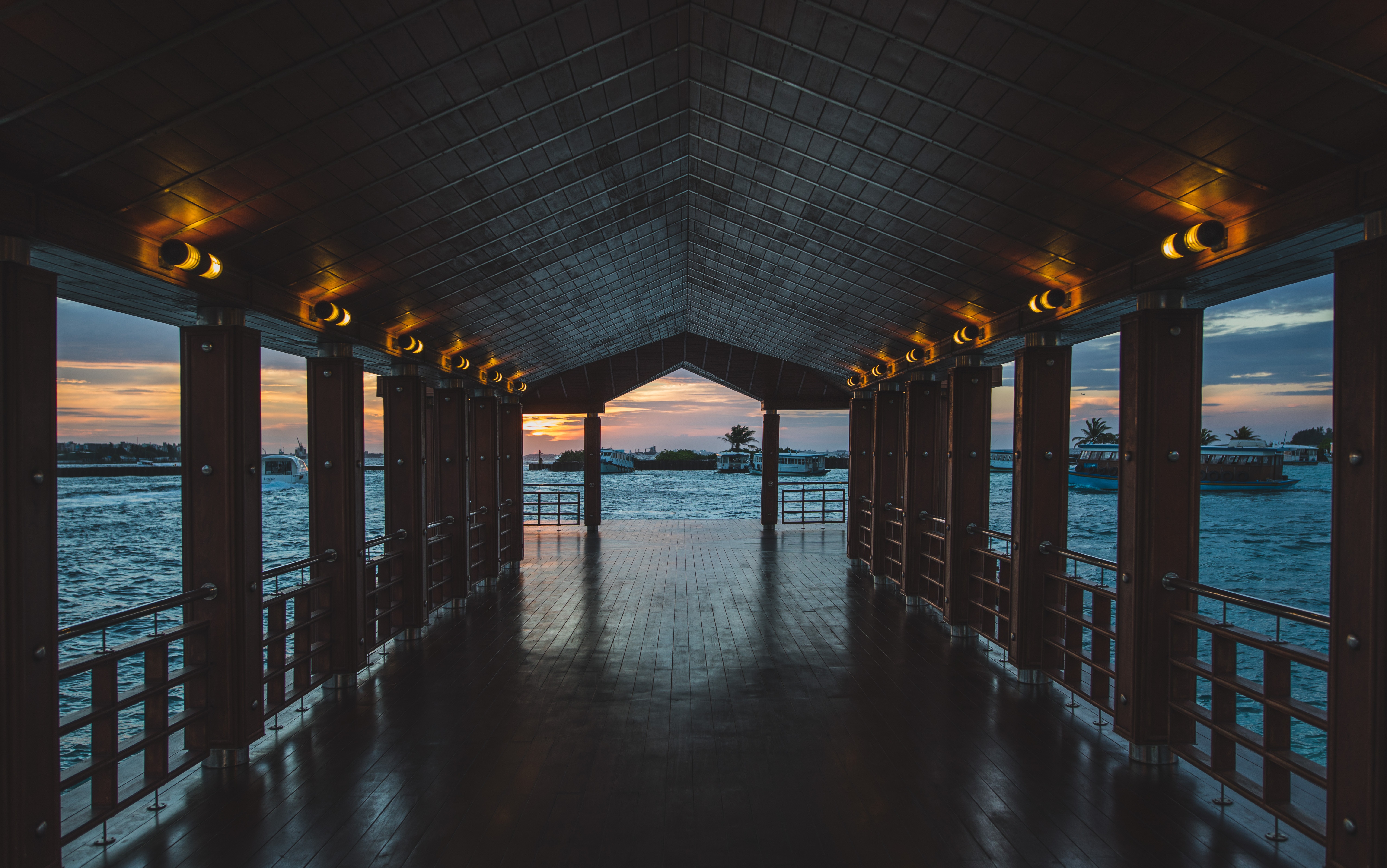 Covered pier at sunset over the water HD Wallpaper