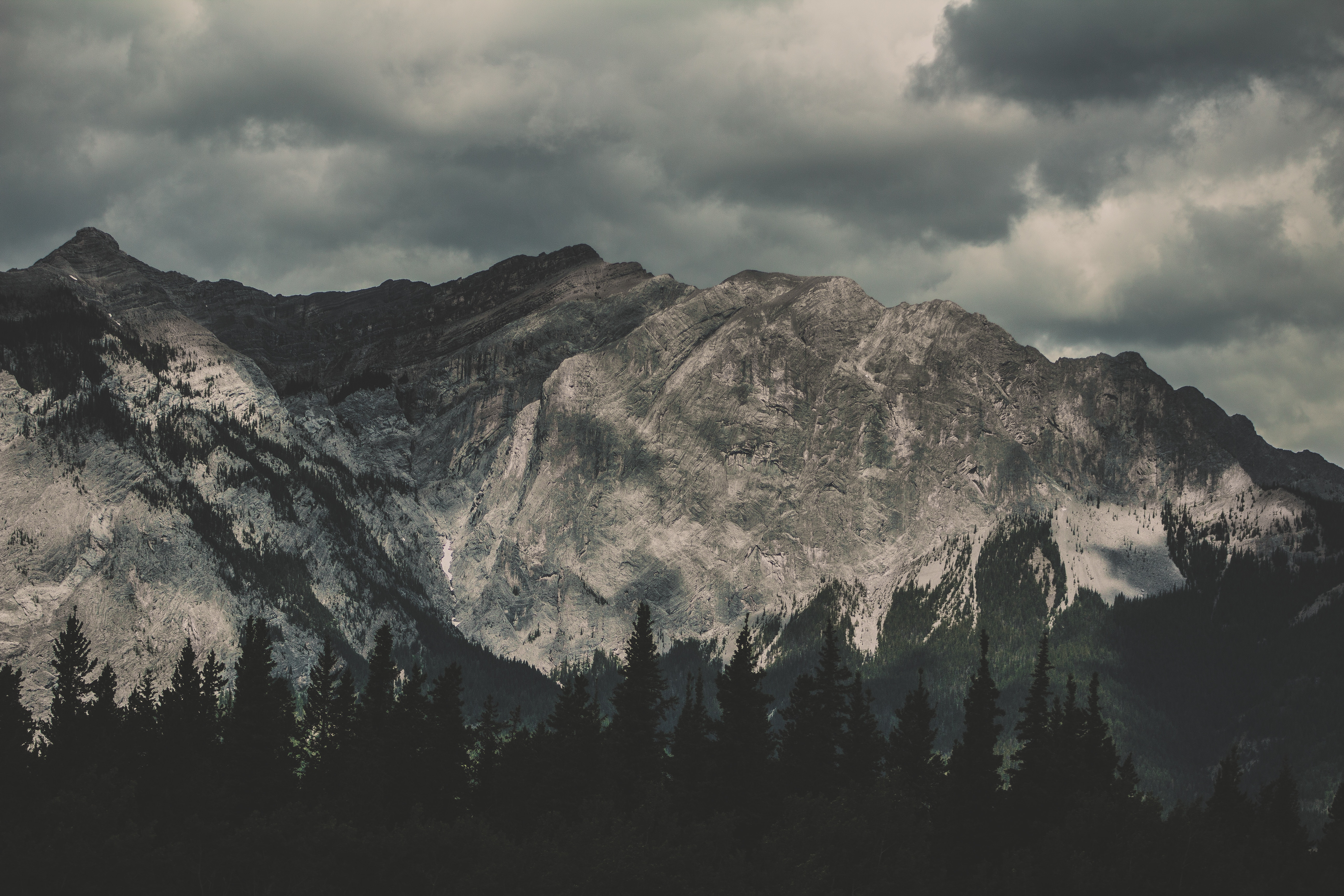 Rocky Mountains under cloudy sky in Banff, Canada HD Wallpaper