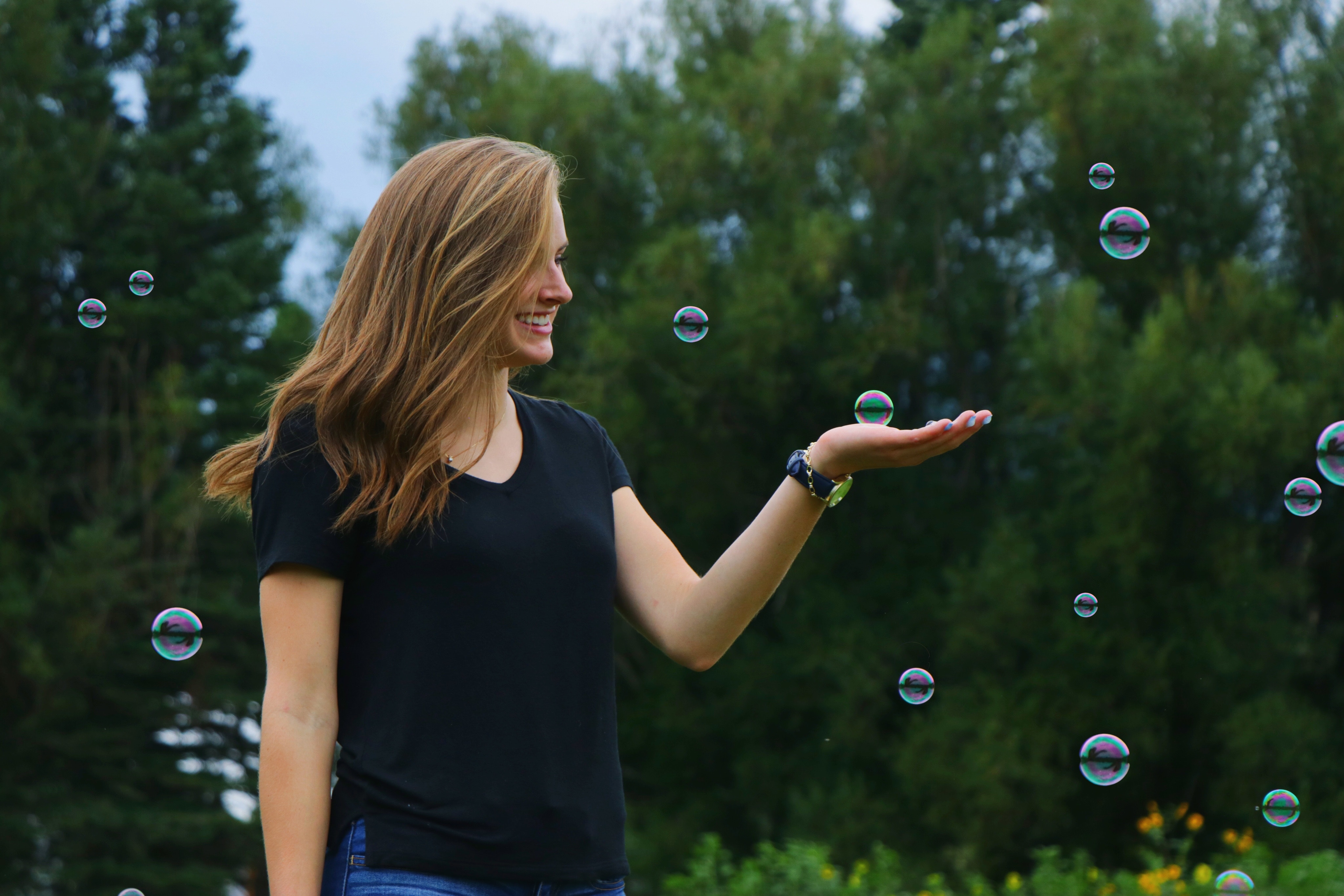 Woman playing with bubbles outdoors HD Wallpaper