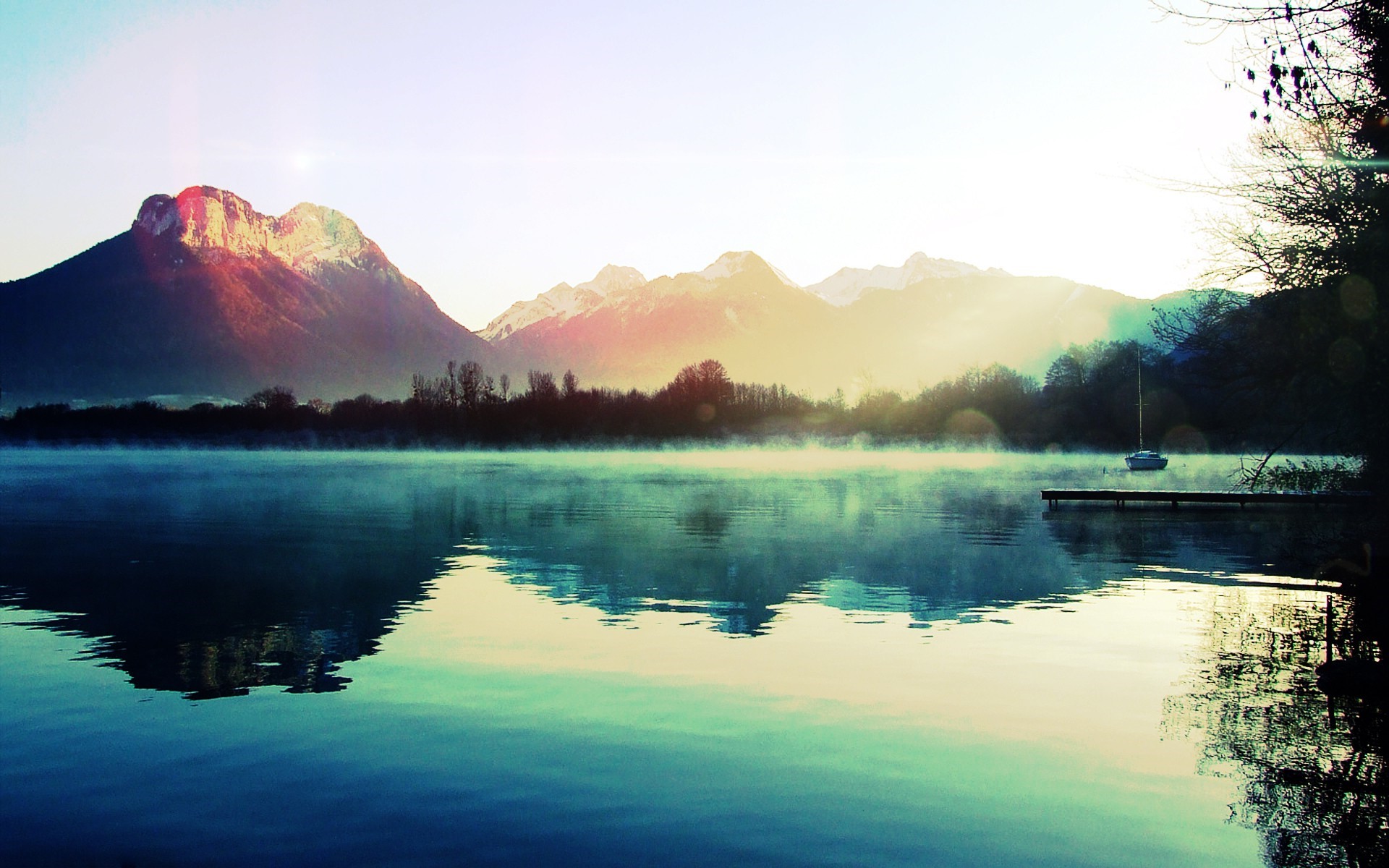 Misty lake with mountains and a pier HD Wallpaper
