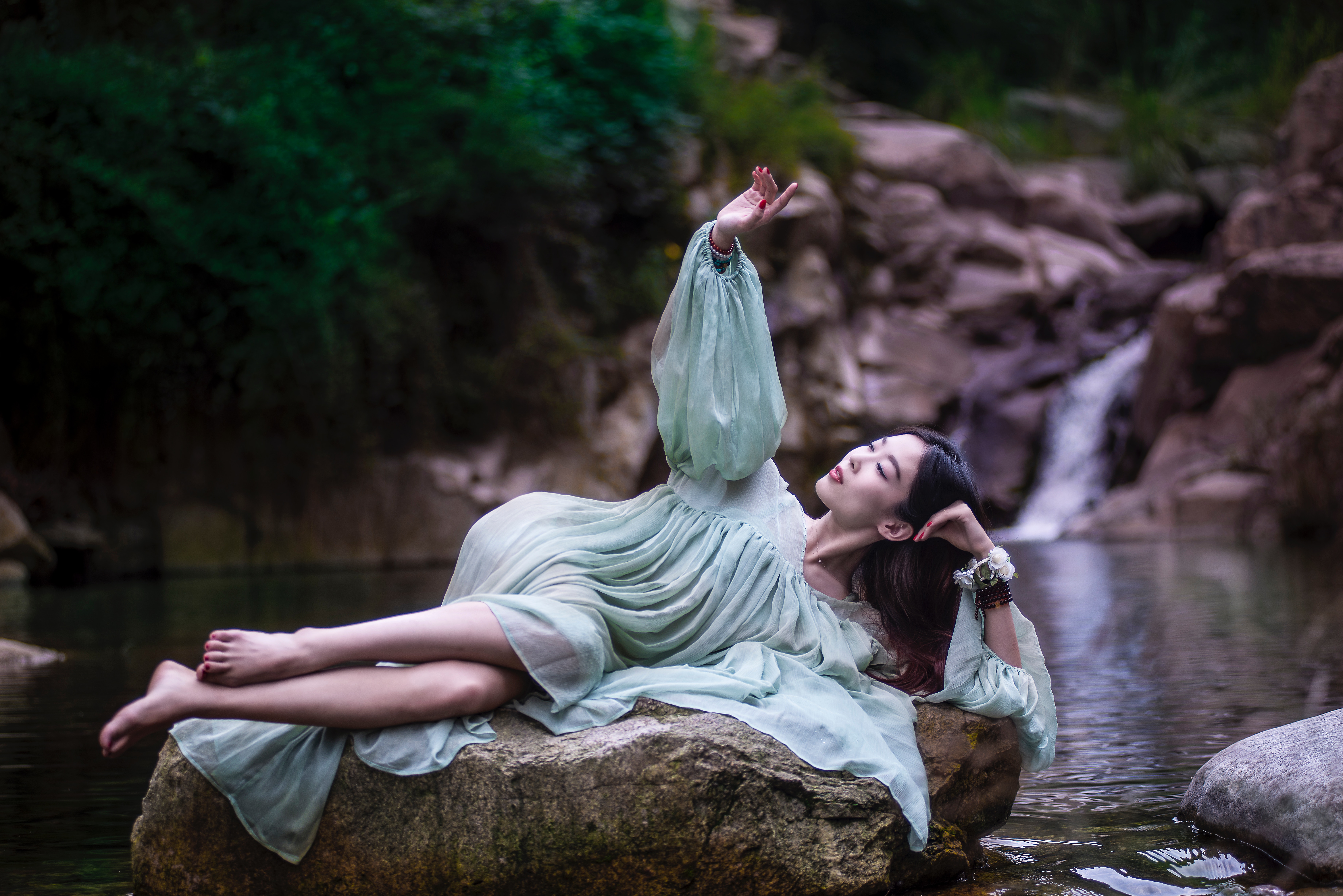 Woman Relaxing on Rock by Forest Stream HD Wallpaper