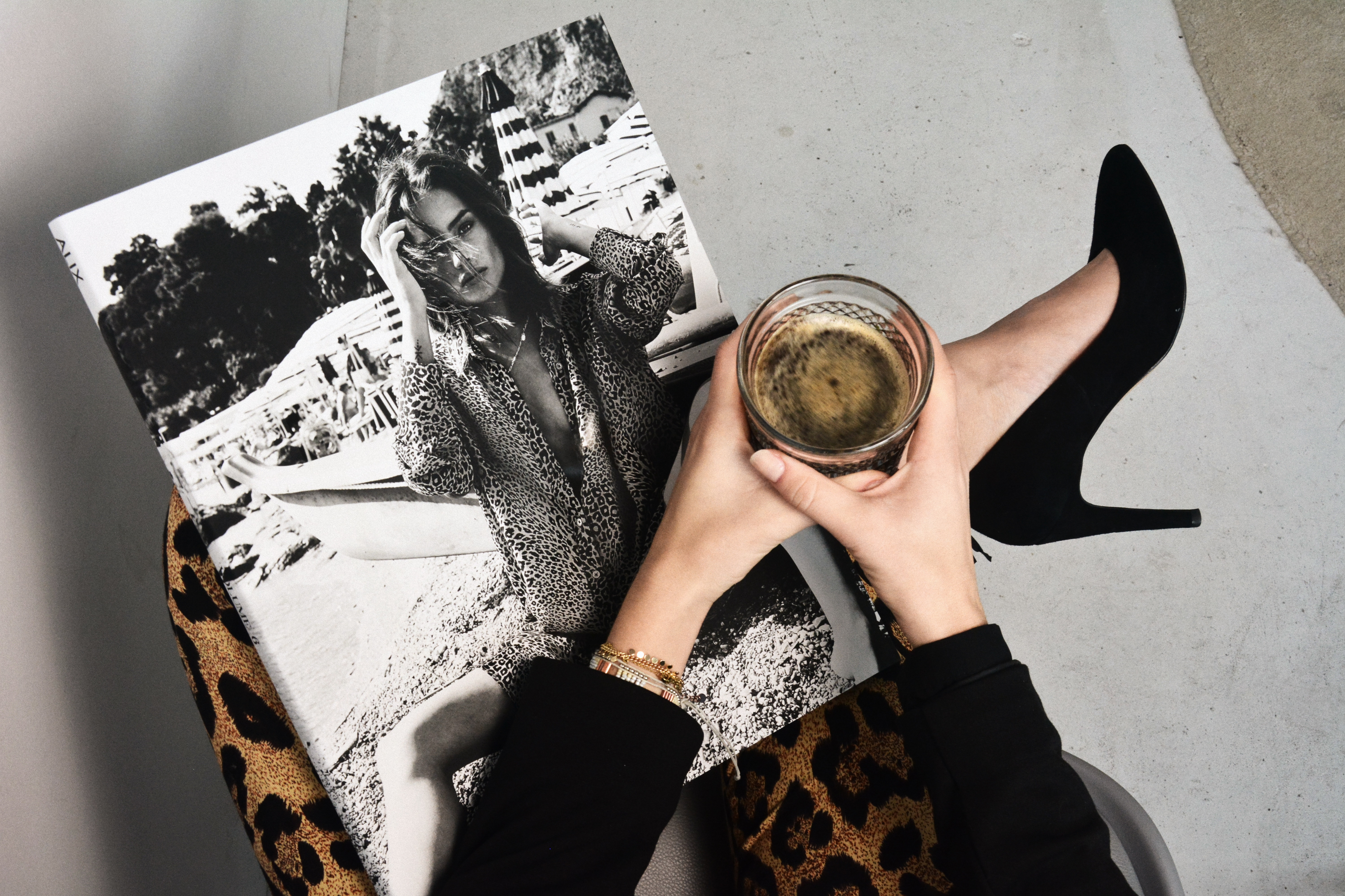 Woman holding coffee next to fashion magazine HD Wallpaper