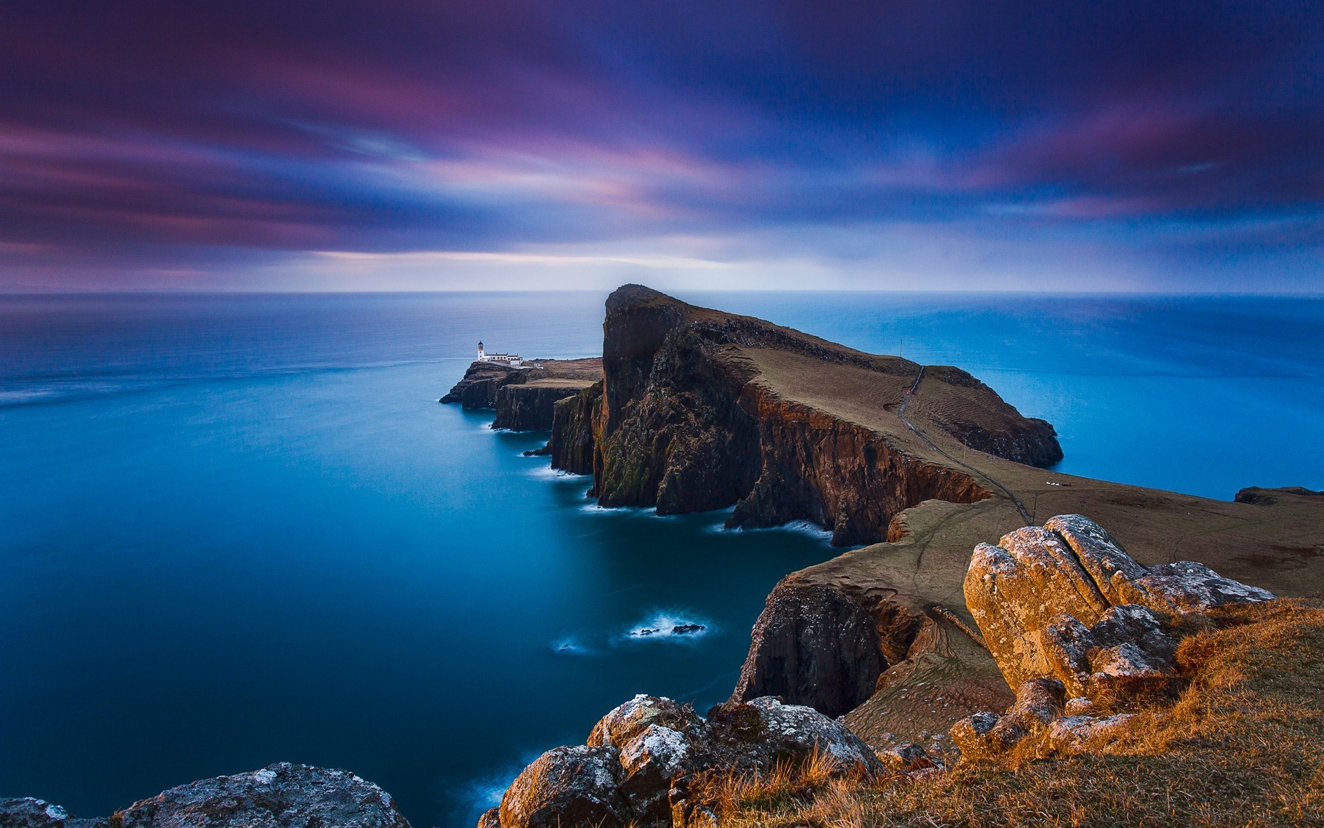 Neist Point Lighthouse on a cliff overlooking the sea HD Wallpaper