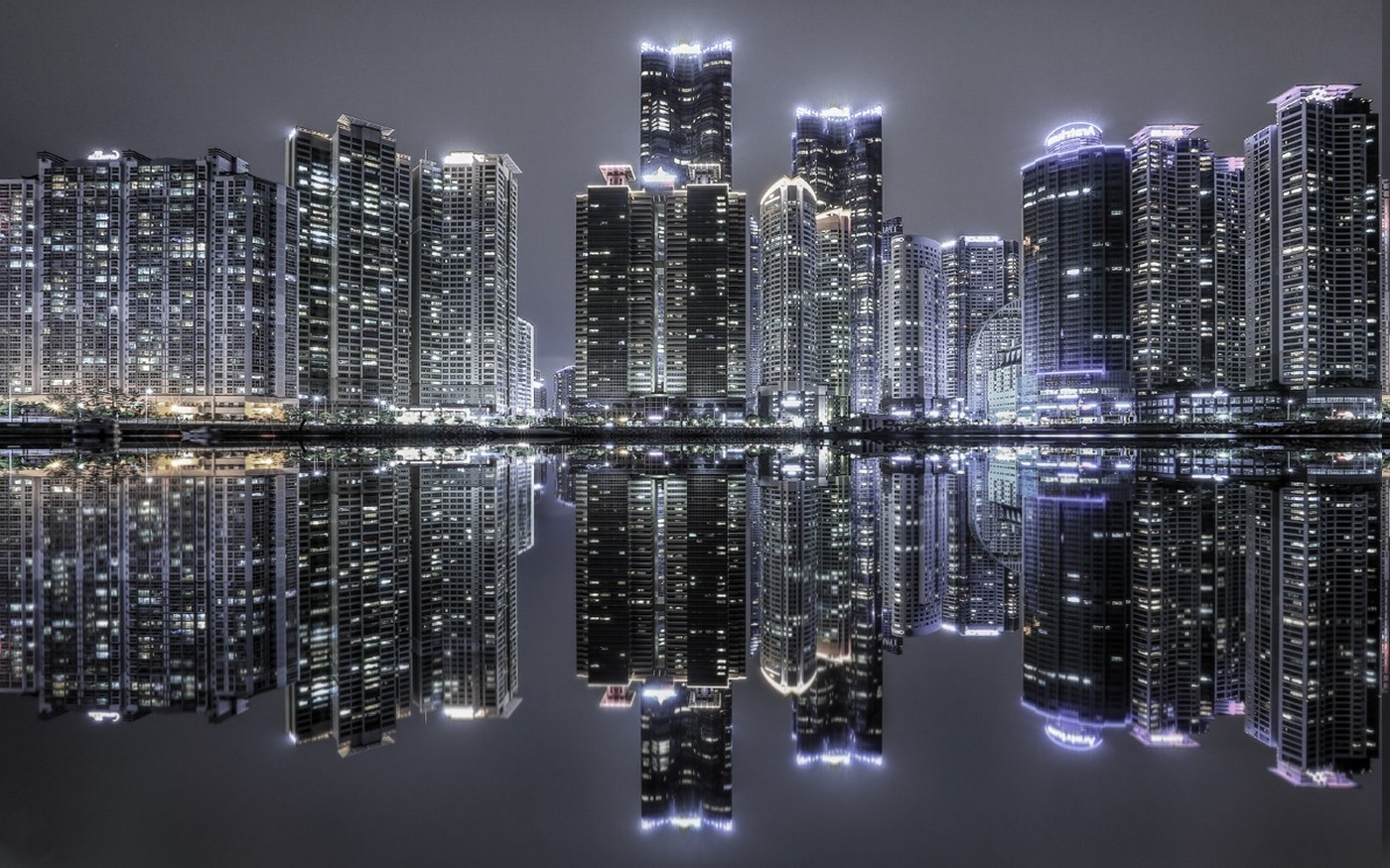 Modern skyscrapers reflected in water at night HD Wallpaper
