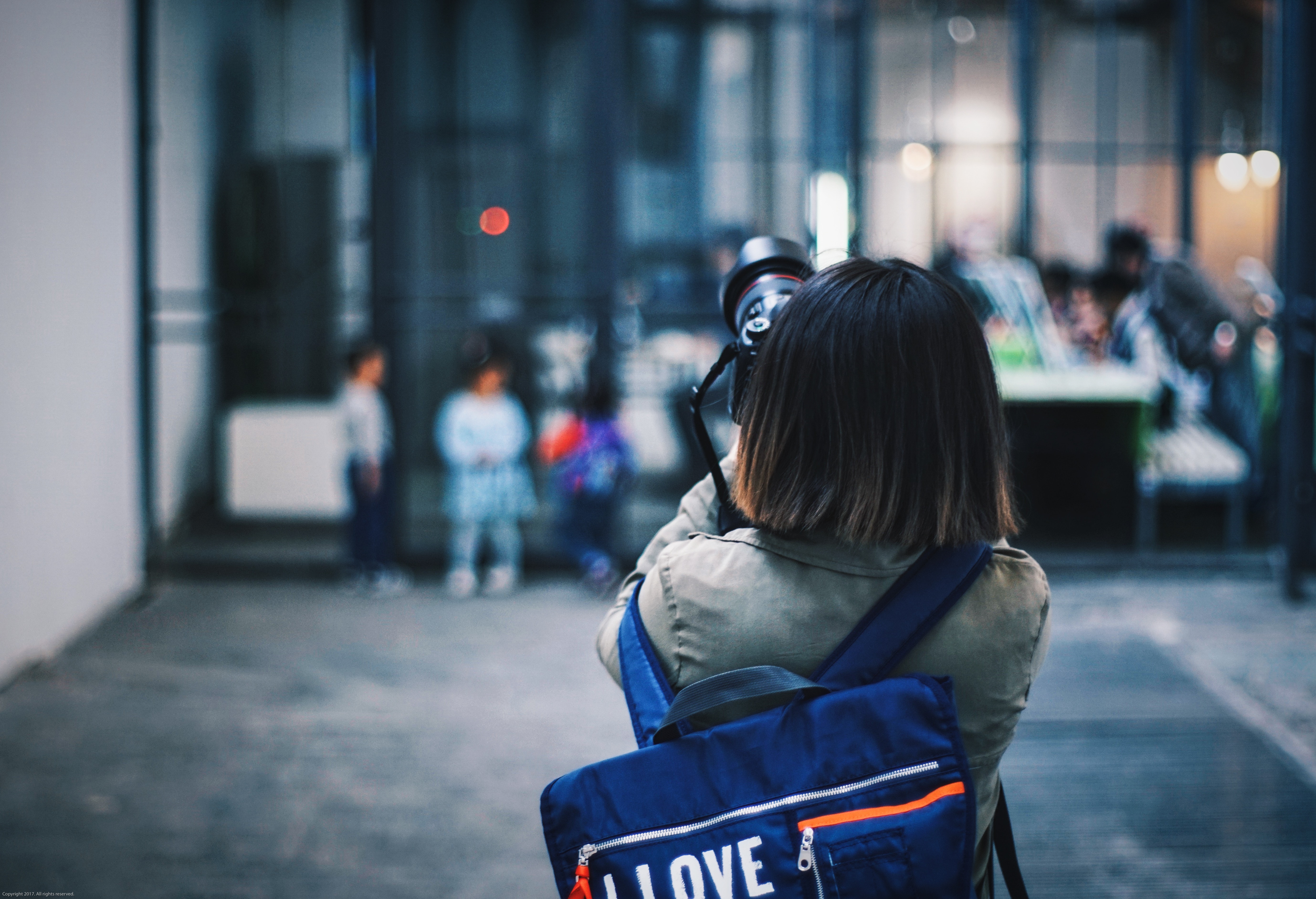 Woman with backpack taking photo of children HD Wallpaper