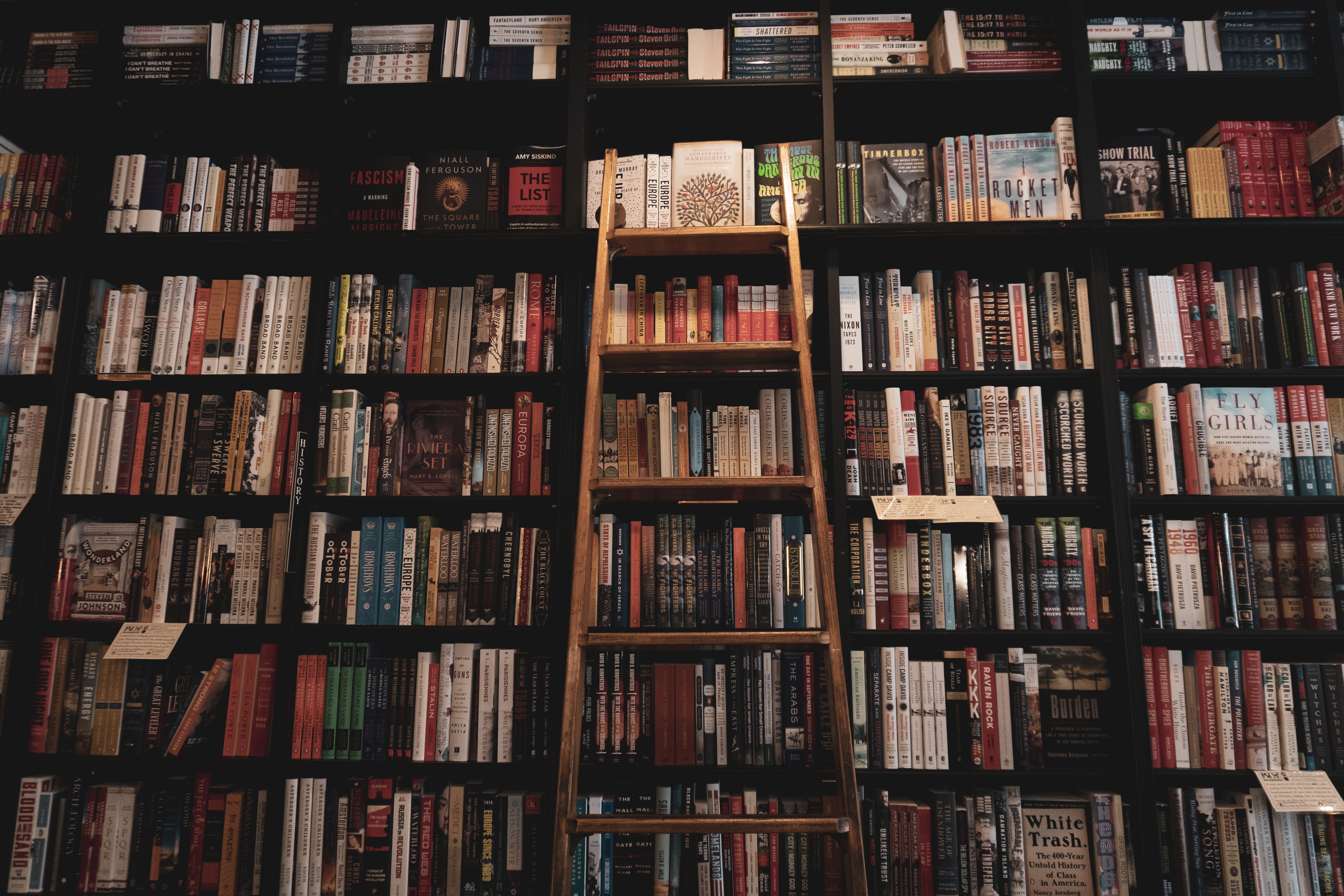 Bookshelf with a ladder in a bookstore HD Wallpaper