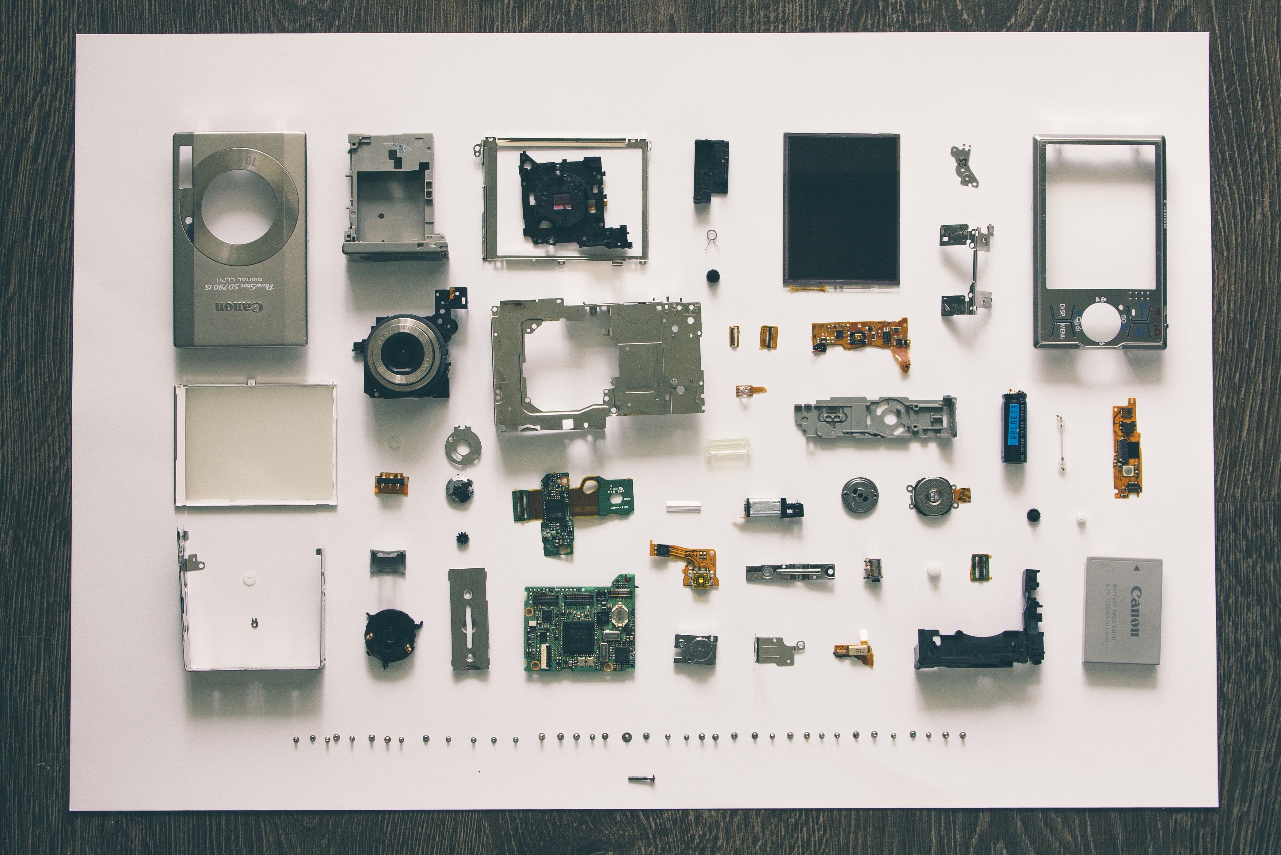 Canon Camera Parts Arranged on White Surface HD Wallpaper