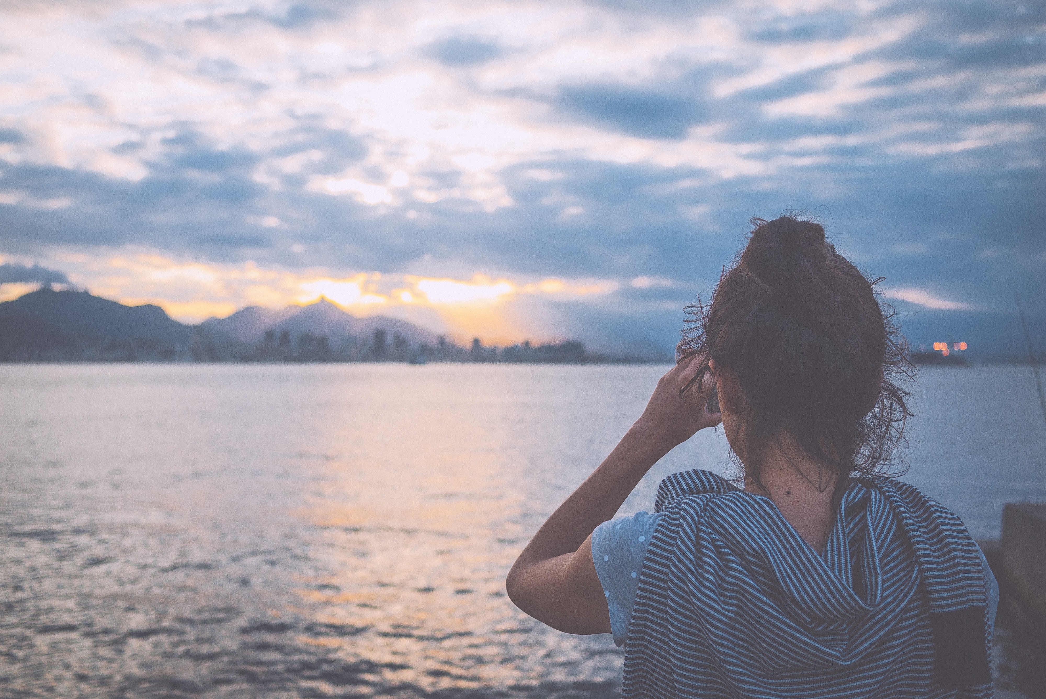 Woman looking at Rio de Janeiro skyline at sunset HD Wallpaper