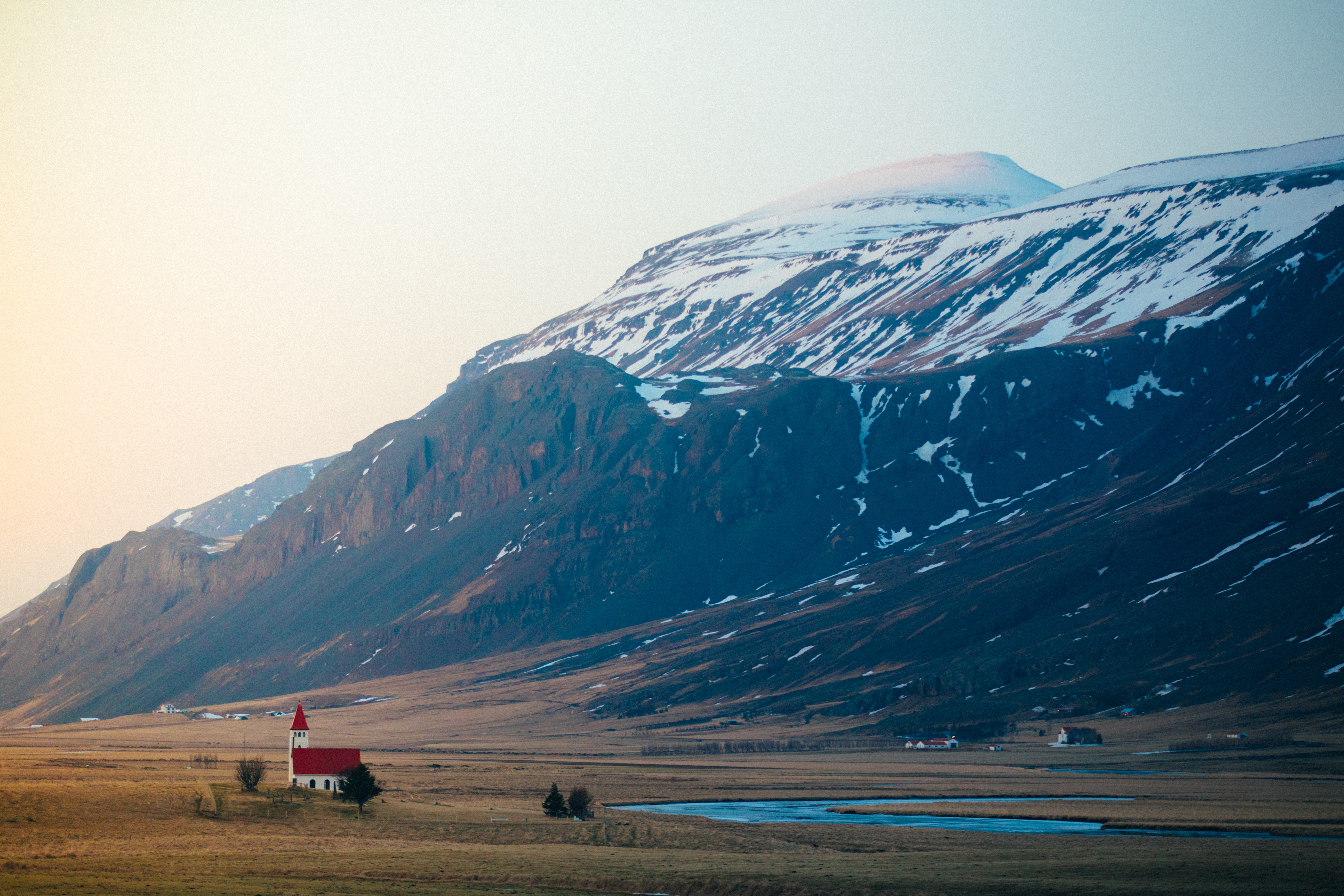 Remote church in a snowy Icelandic valley at sunset HD Wallpaper