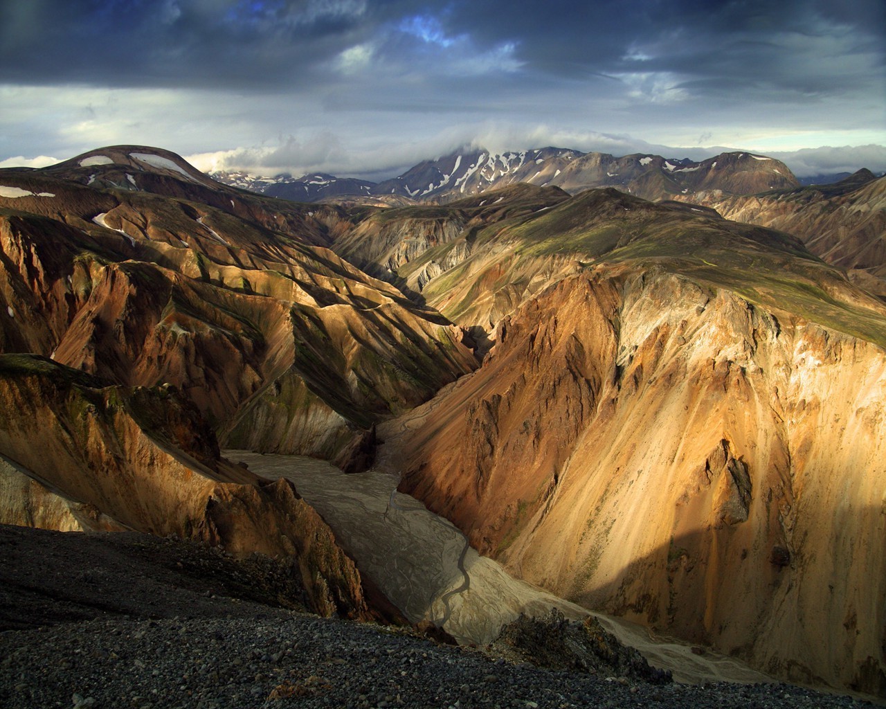 Icelandic mountain landscape with colorful hills and a riverbed HD Wallpaper
