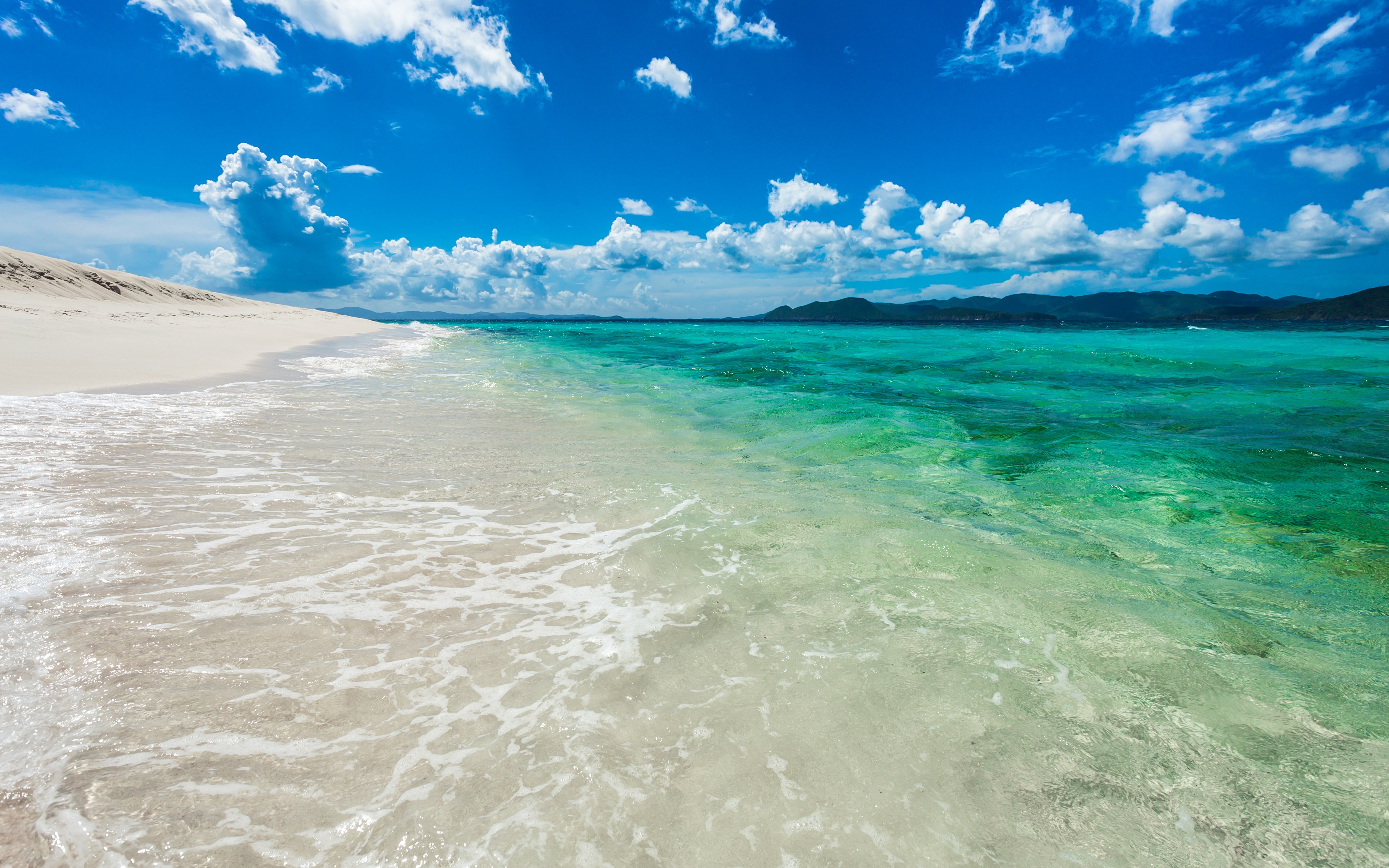 Beach with turquoise water and white sand under blue sky HD Wallpaper