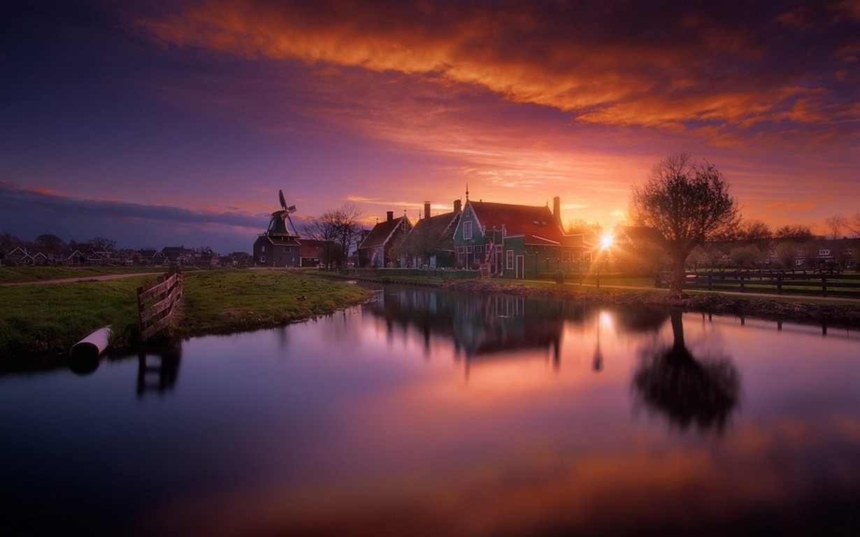 Sunset over Dutch village with windmill and canal HD Wallpaper