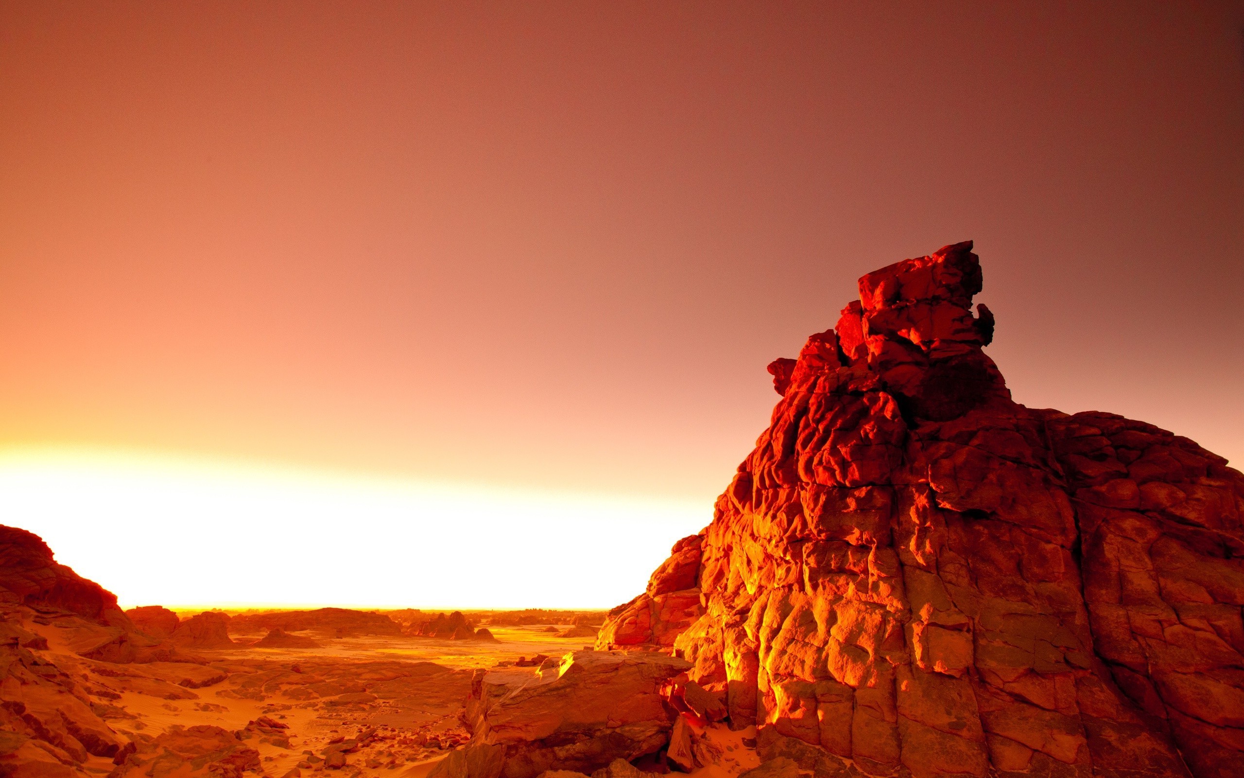 Desert rock formation at sunset HD Wallpaper