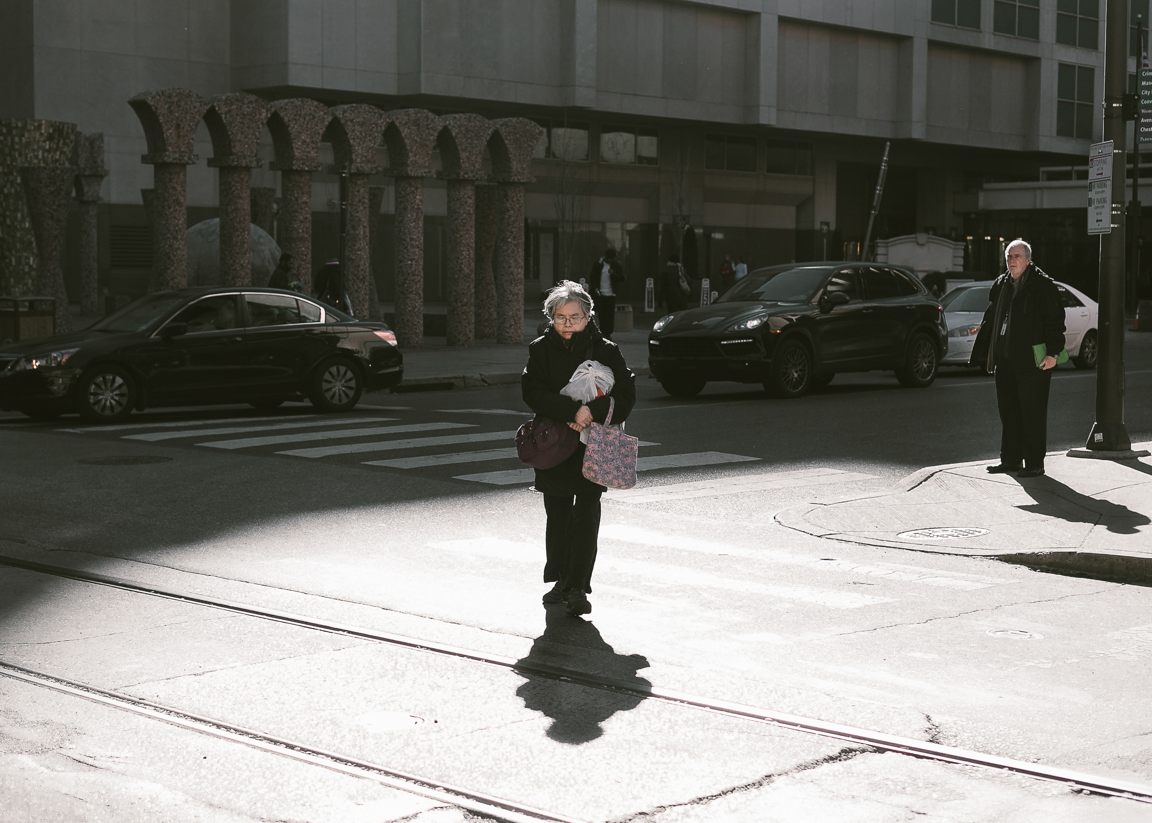 Elderly woman crossing street with bags HD Wallpaper
