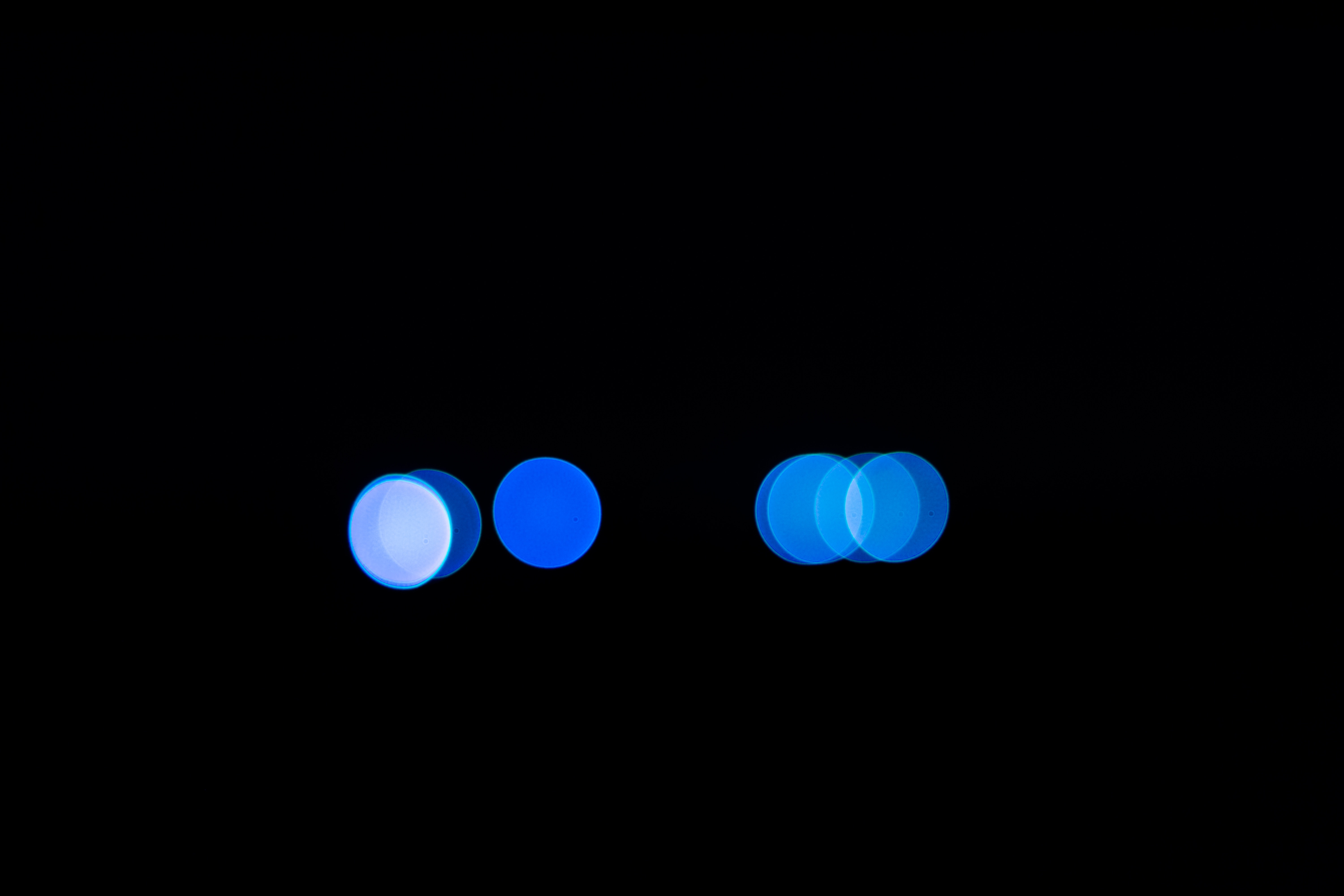 Blue bokeh circles on a black background HD Wallpaper