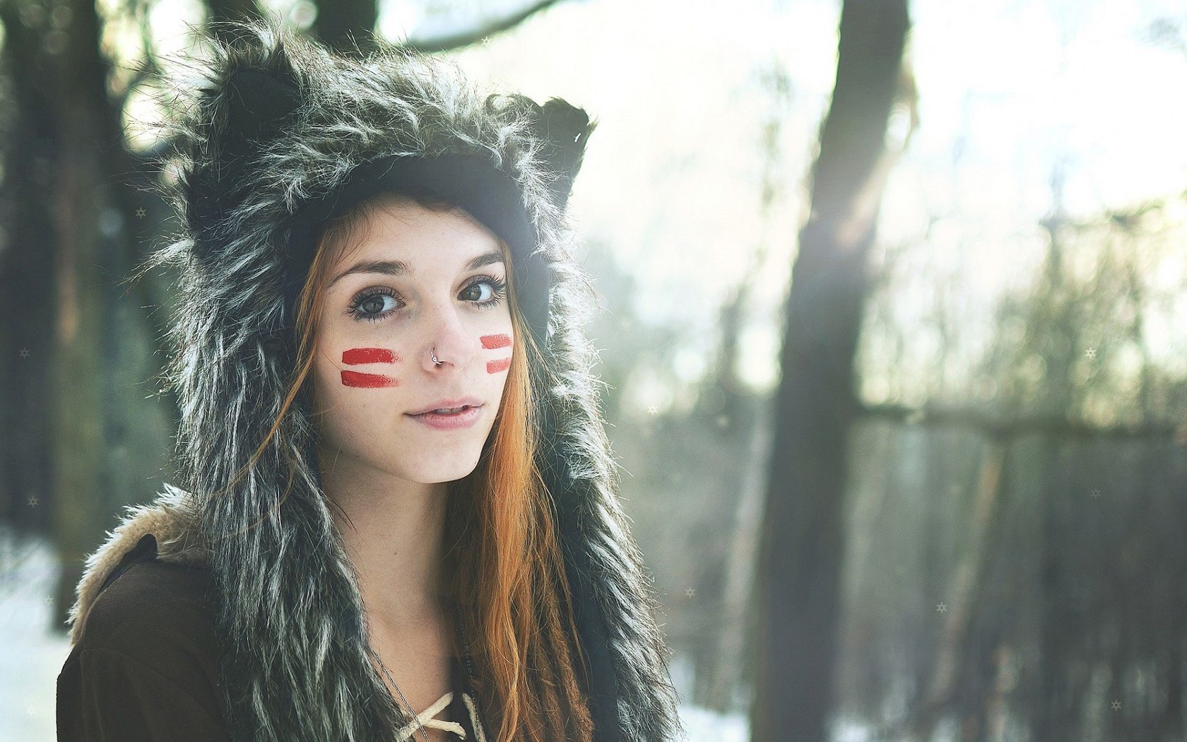 Woman with wolf hat and face paint in forest HD Wallpaper
