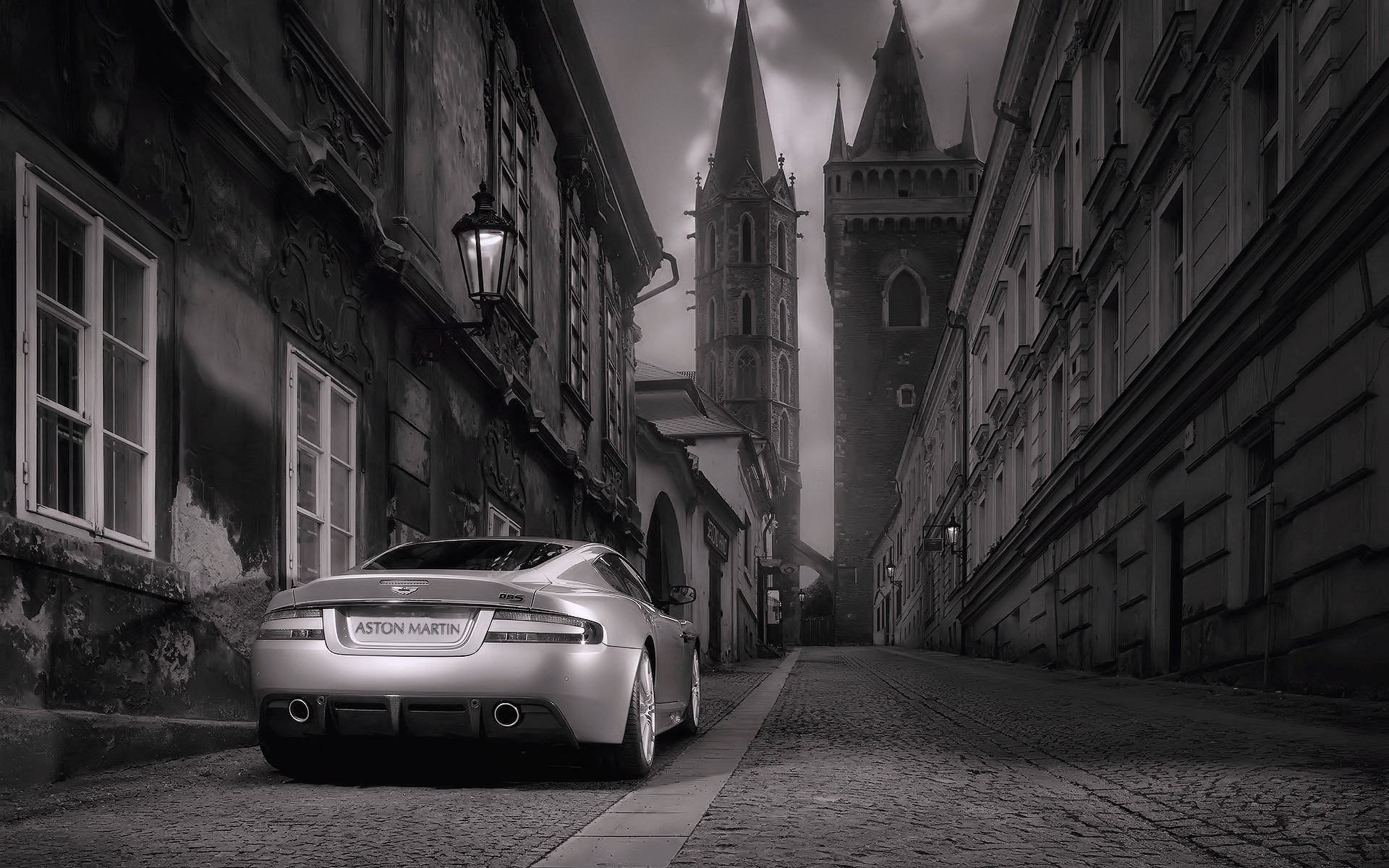 Aston Martin DBS on a cobblestone street in Prague HD Wallpaper