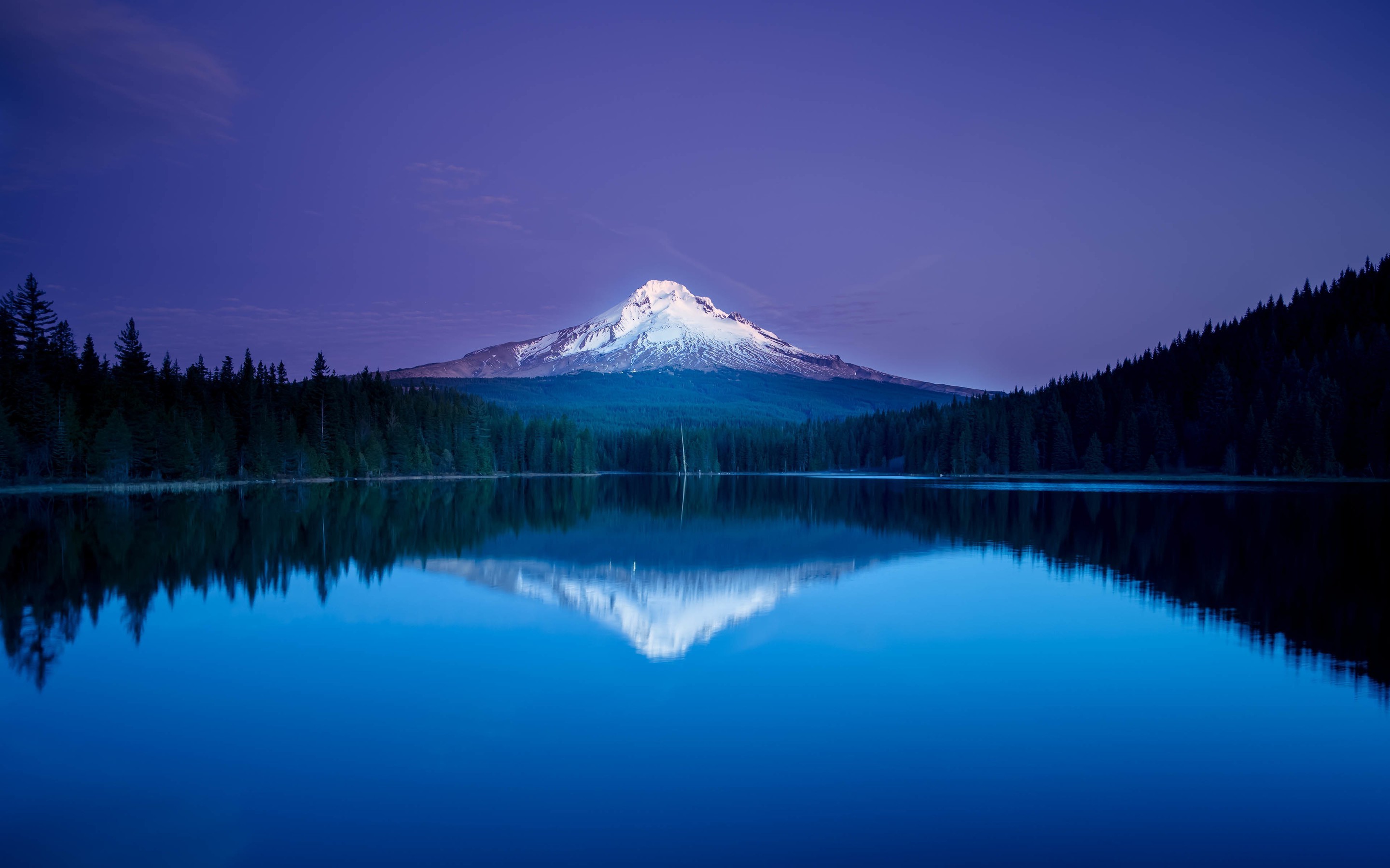 Snow-capped mountain reflected in a blue lake at dusk HD Wallpaper