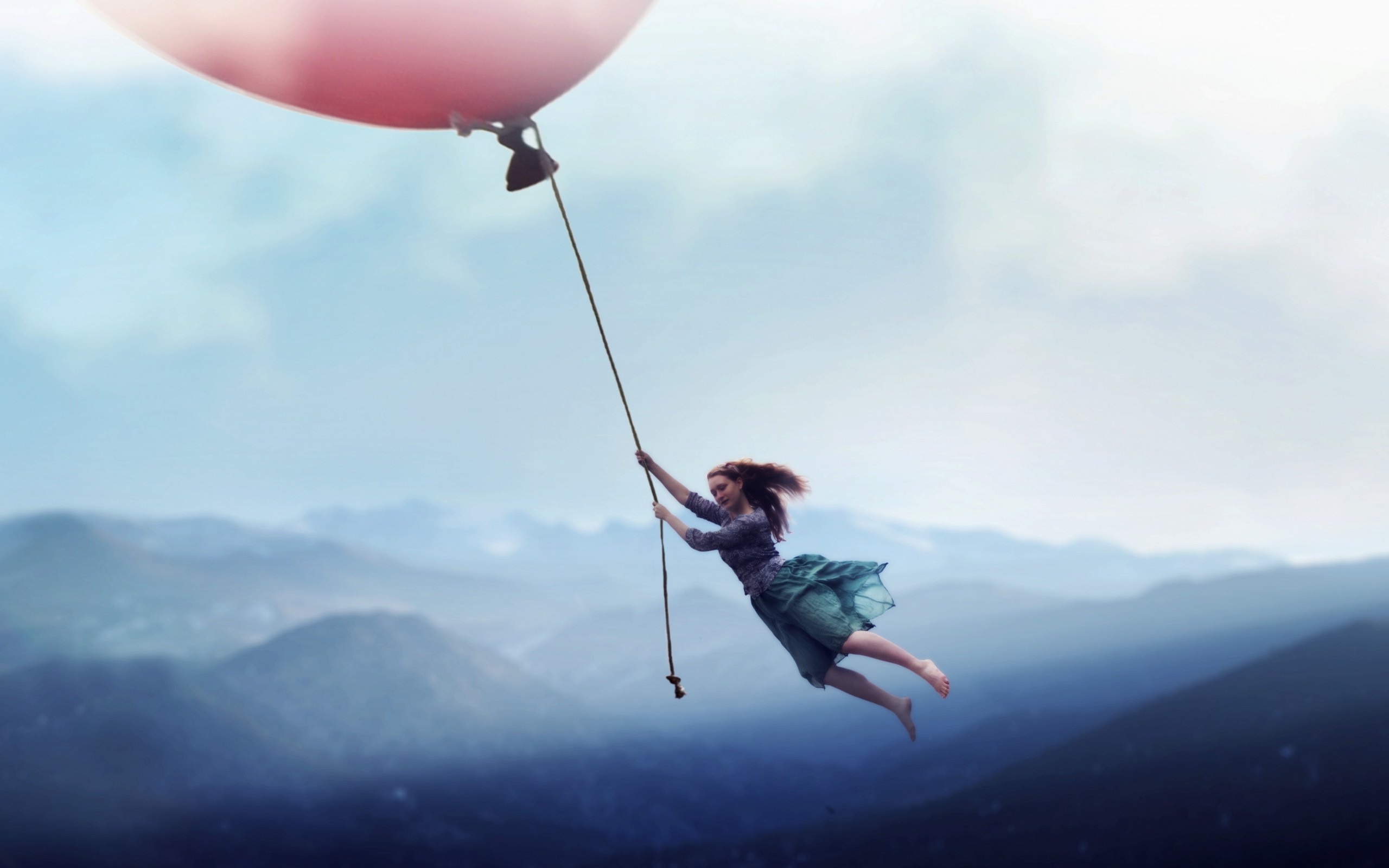 Woman holding onto a balloon flying over mountains HD Wallpaper