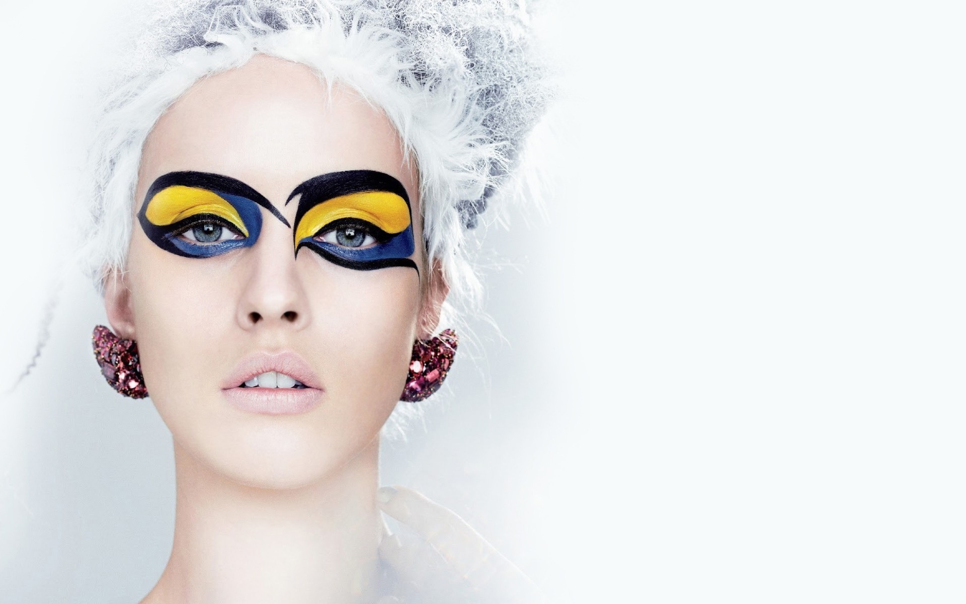 Model with dramatic blue and yellow eye makeup HD Wallpaper