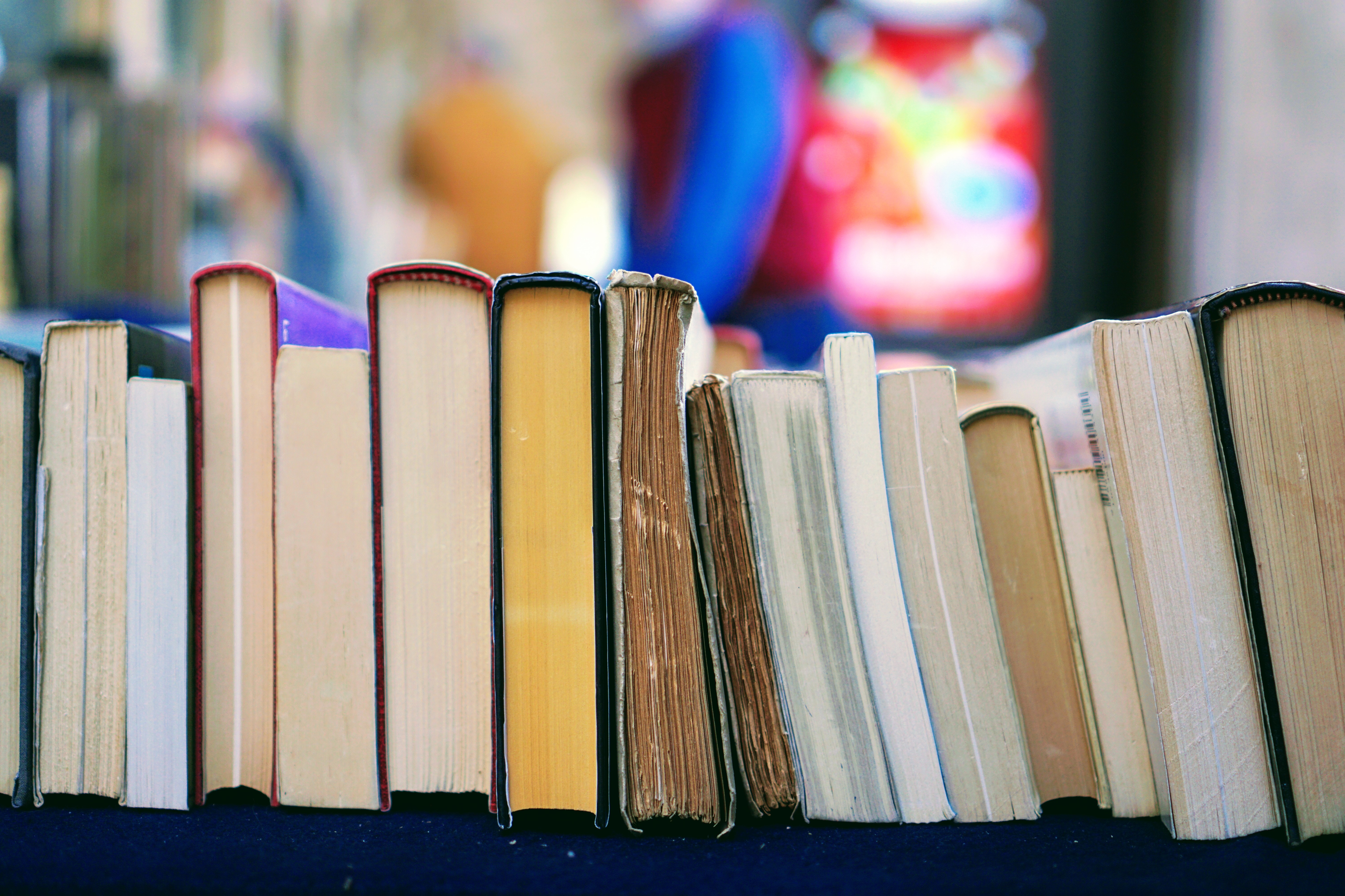 A row of books with colorful blurred background HD Wallpaper